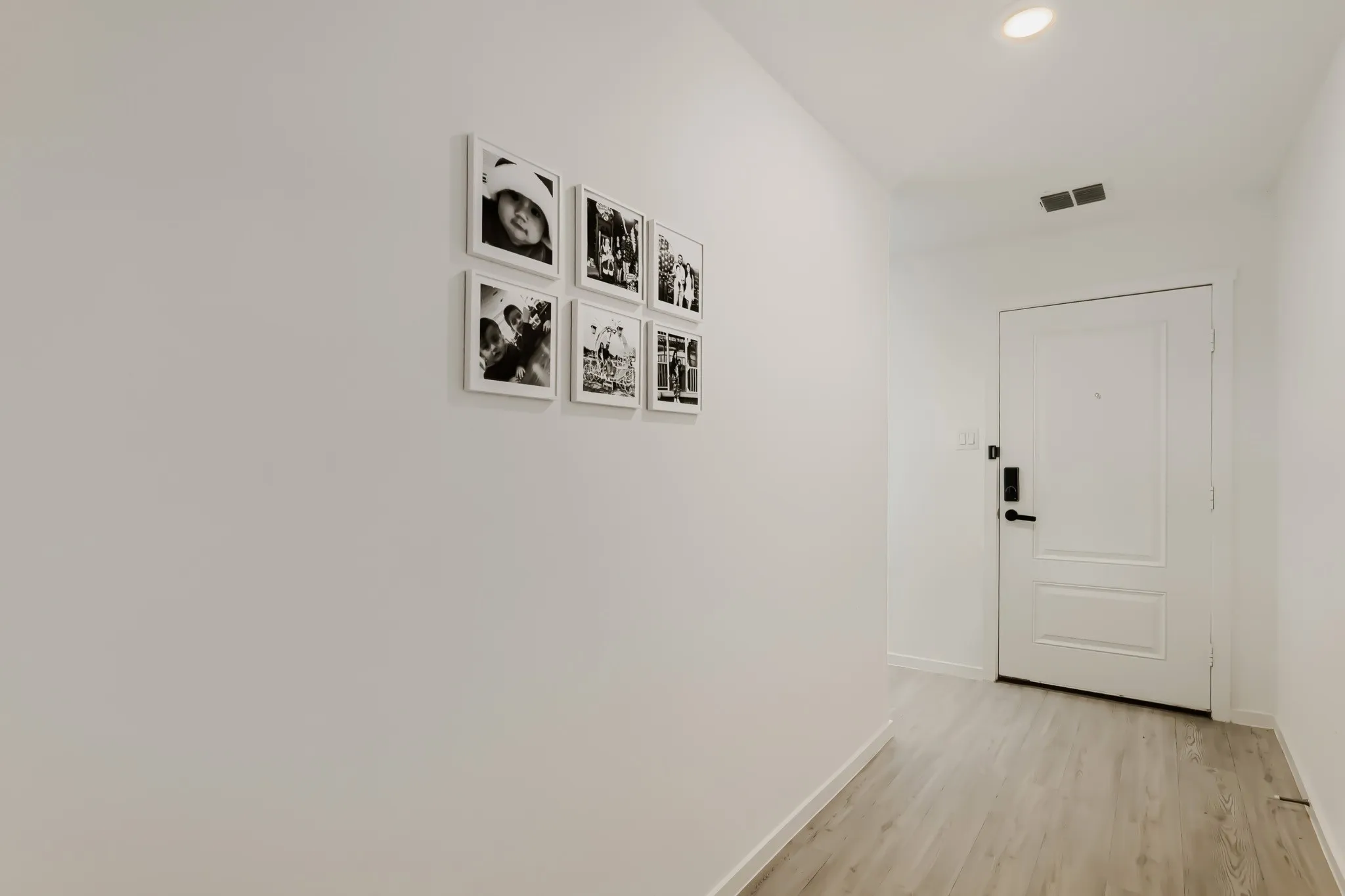 Light wood-finish flooring with recessed ceiling lighting