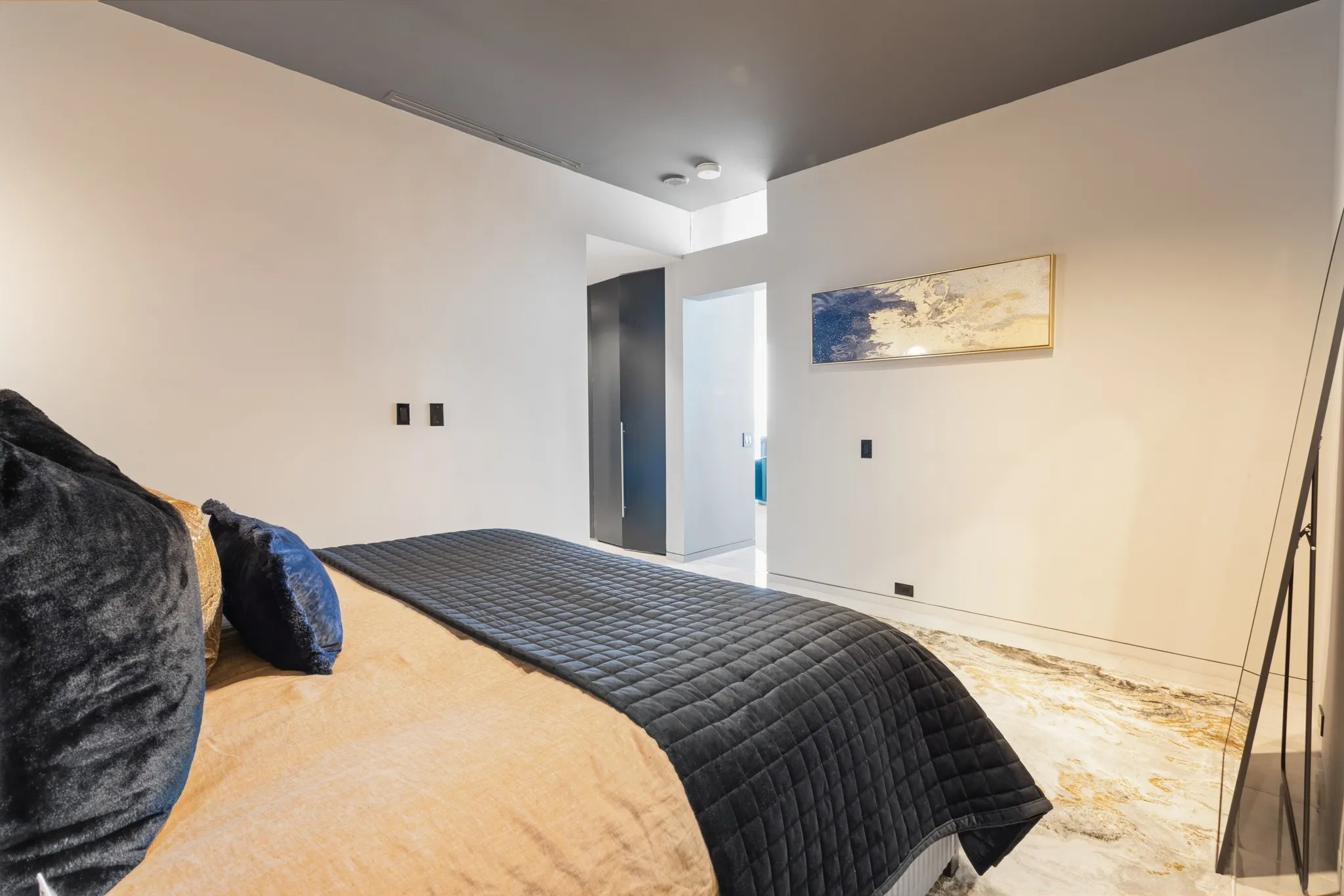 White walls with a dark accent ceiling, recessed lighting, and tile flooring