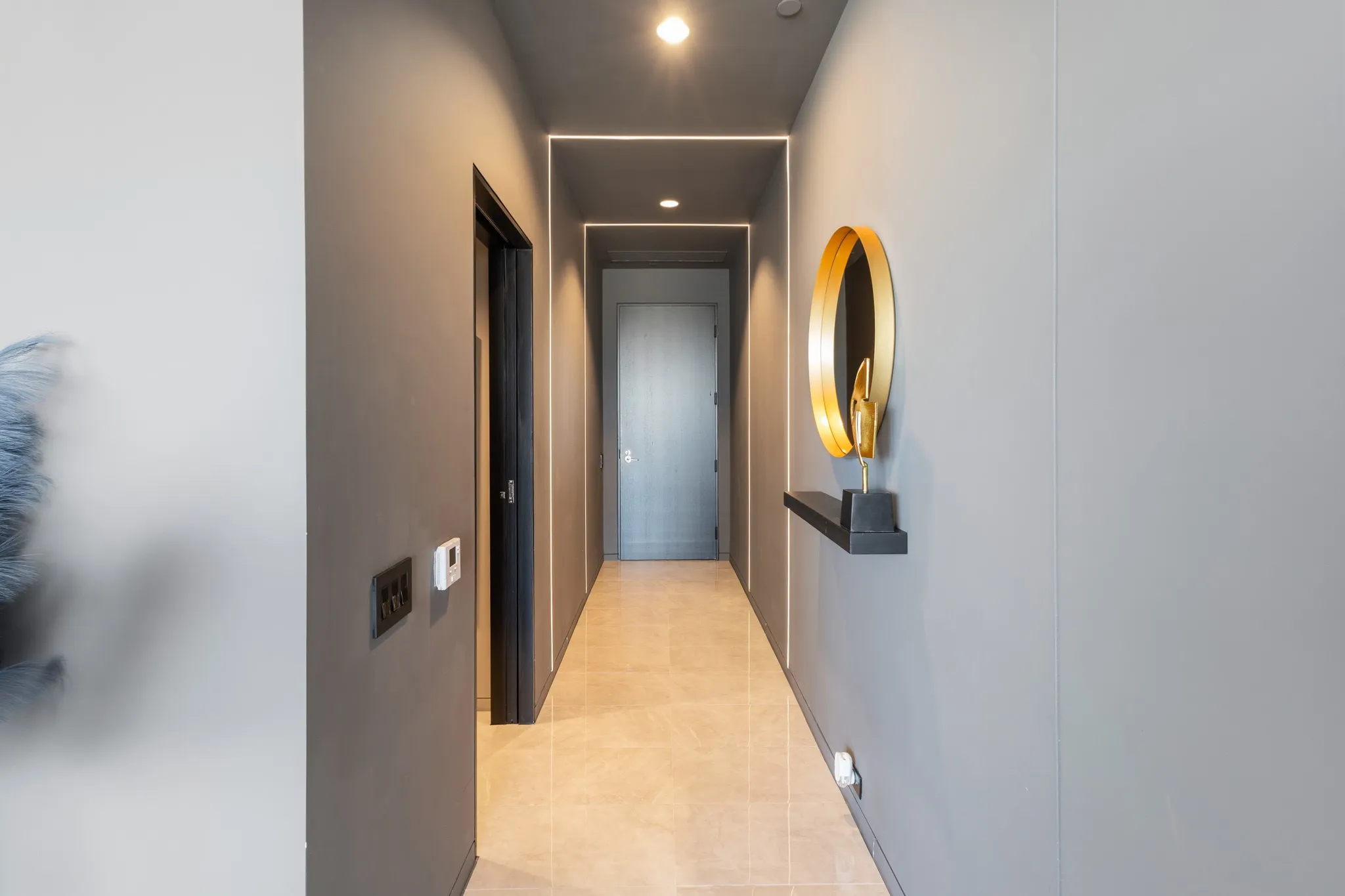 Recessed ceiling lighting, linear strip lighting, flush-mount doors, and tile flooring