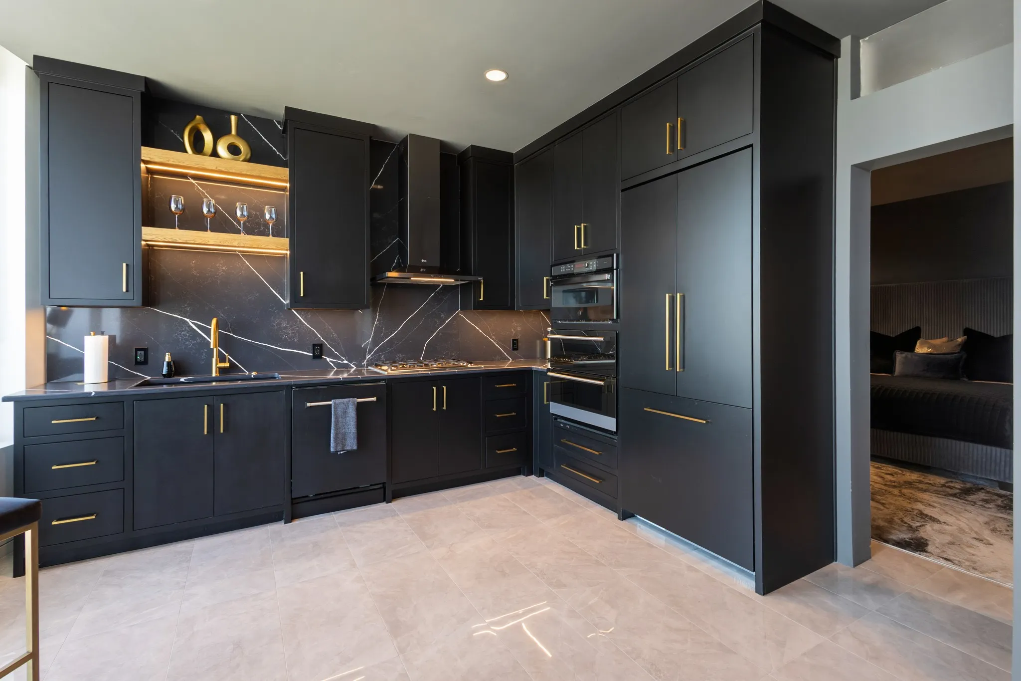 Integrated black cabinetry with gold-tone hardware