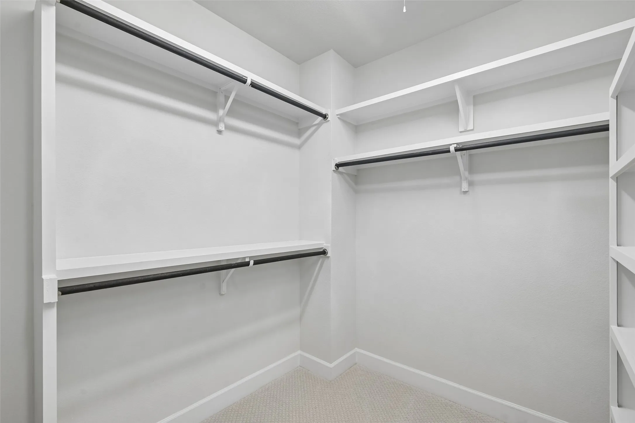 one section of primary walk-in closet