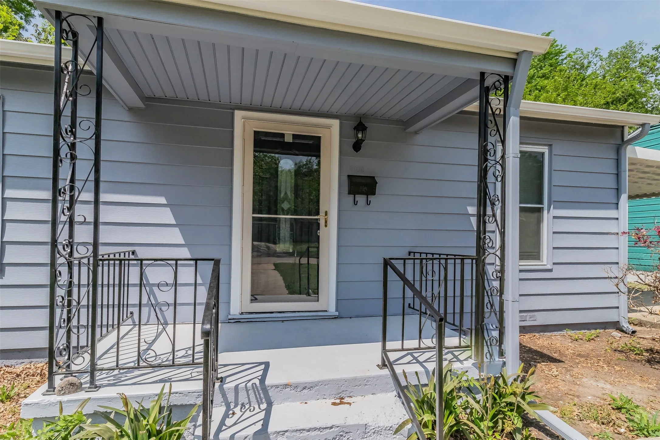 Exterior featuring horizontal siding and a covered porch