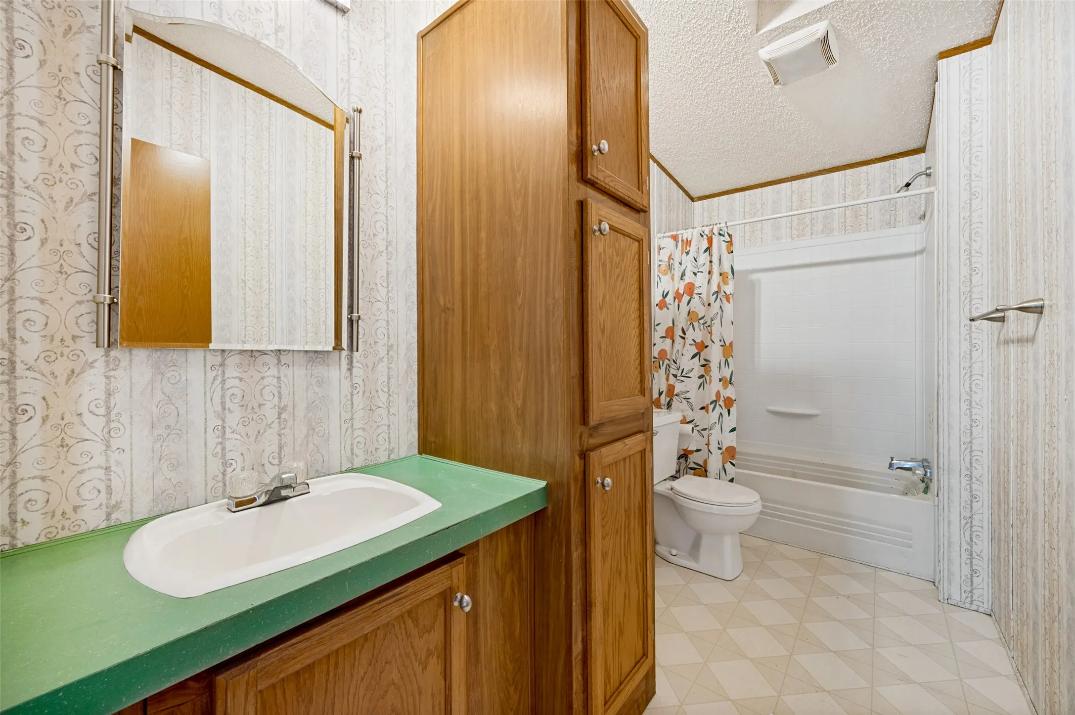 Secondary bathroom with lots of cabinets for storage.