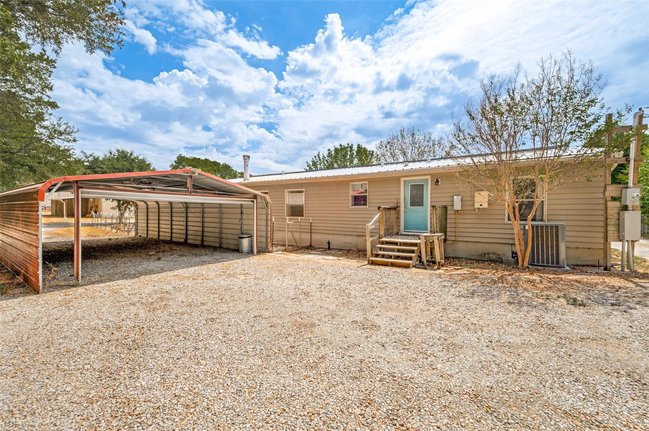 Back of the home with large detached carport 20 x 40, should  fit 4 vehicles.