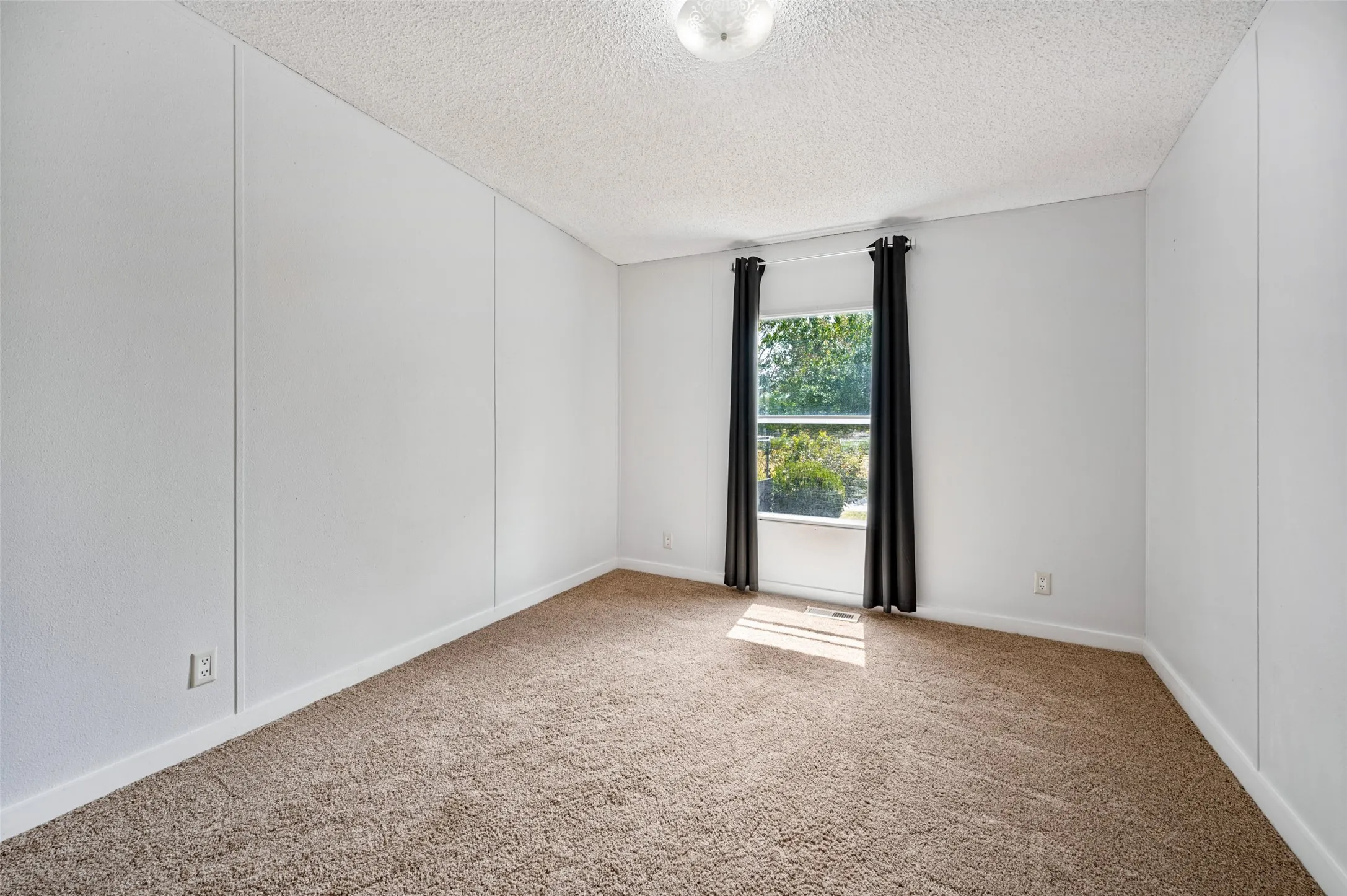 Secondary bedroom with carpet.