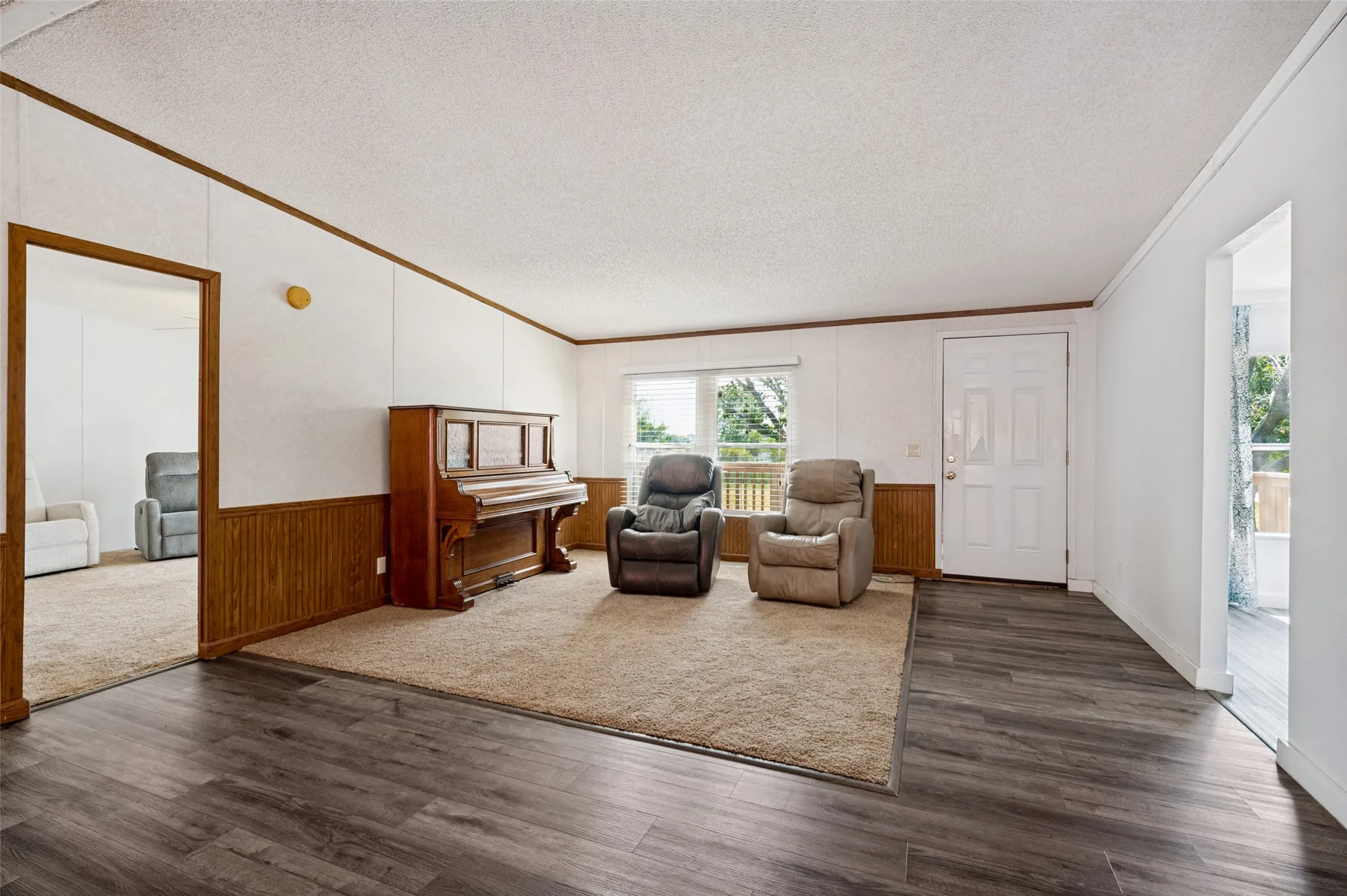 Formal living can be formal dining.  Entry with wood paneling, crown molding and LVP flooring