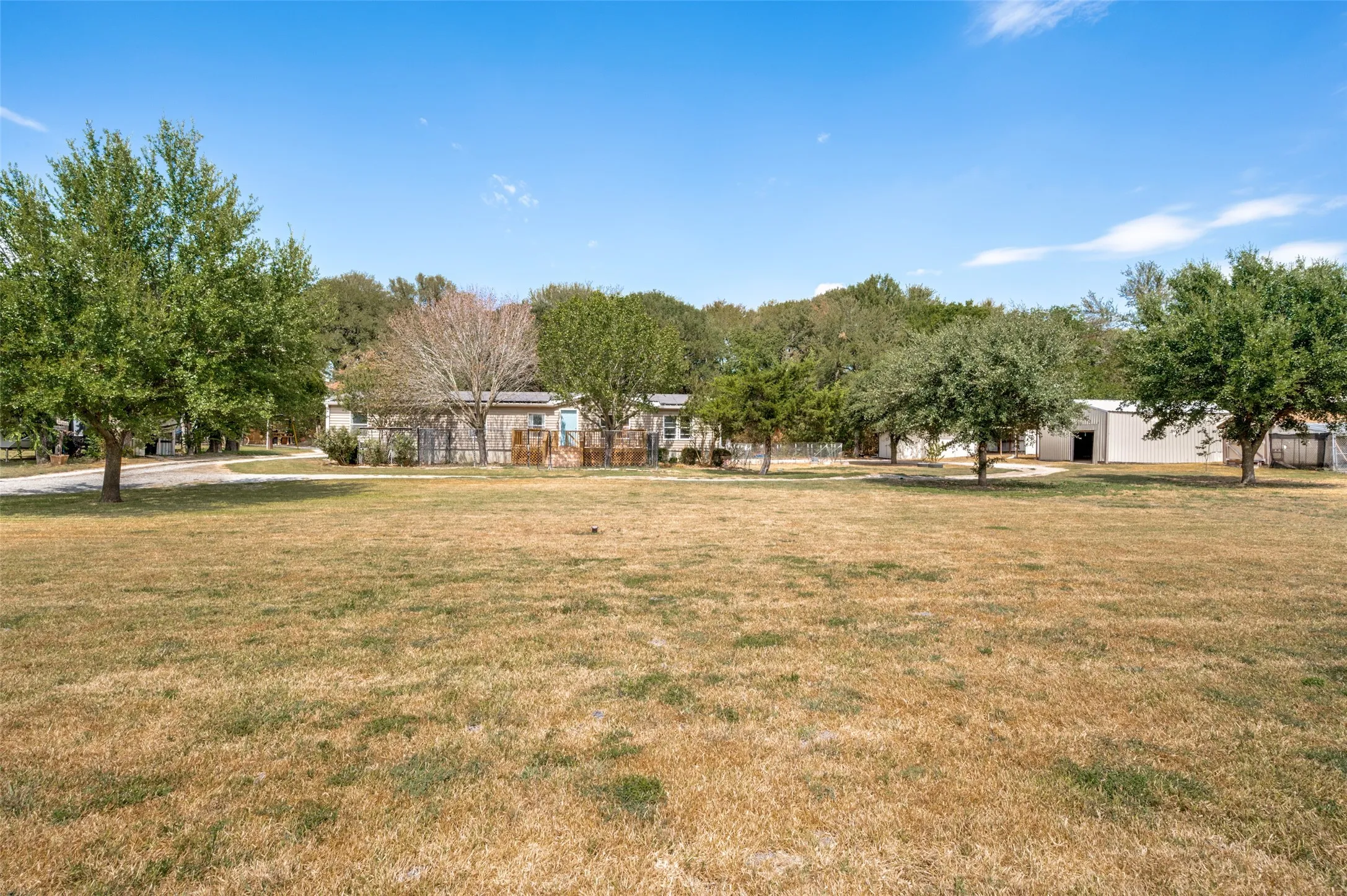 Large front yard with circular driveway that leads around the home and lots of storage for all of your outdoor toys.