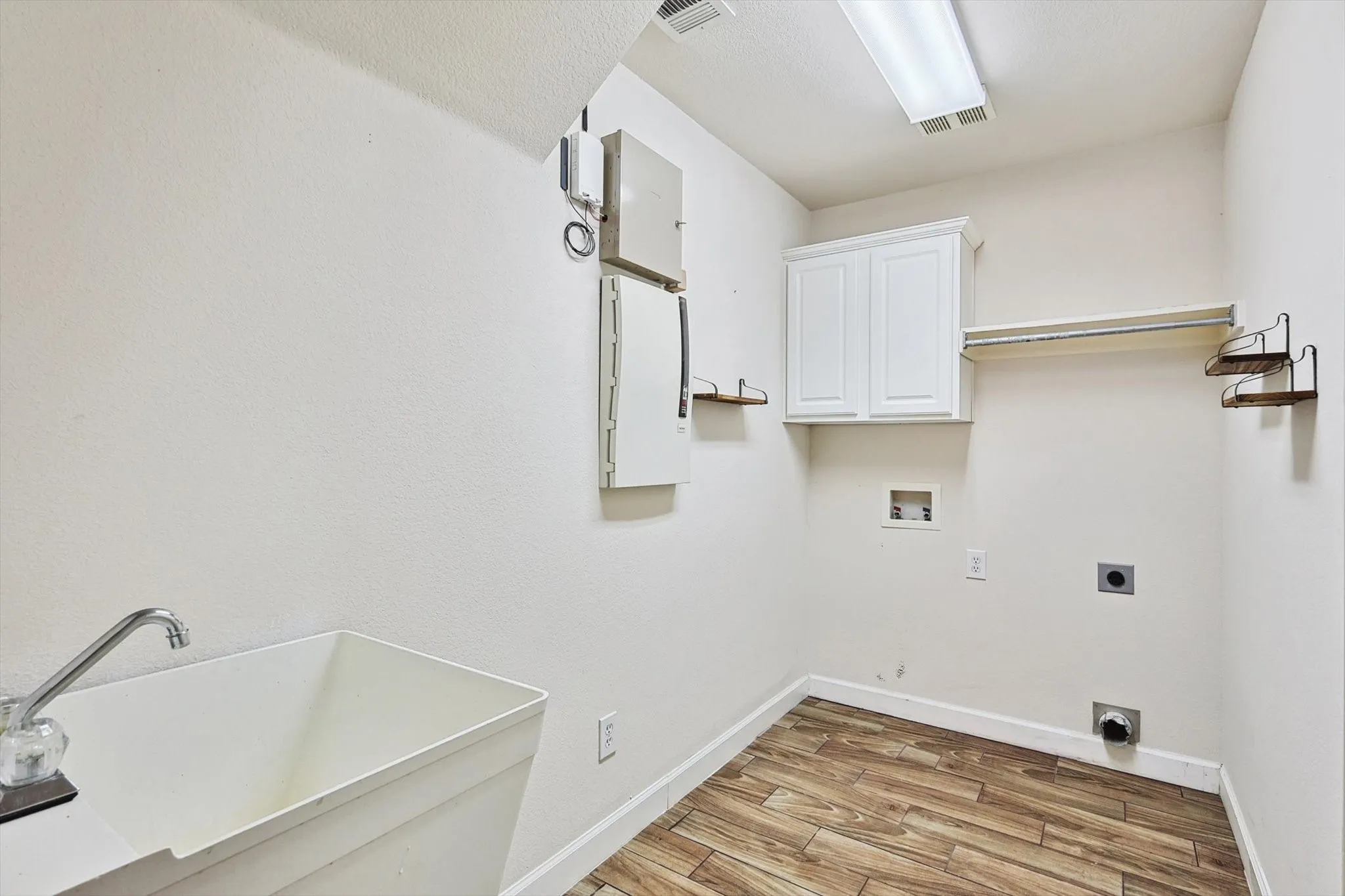 The utility room features a sink and storage.