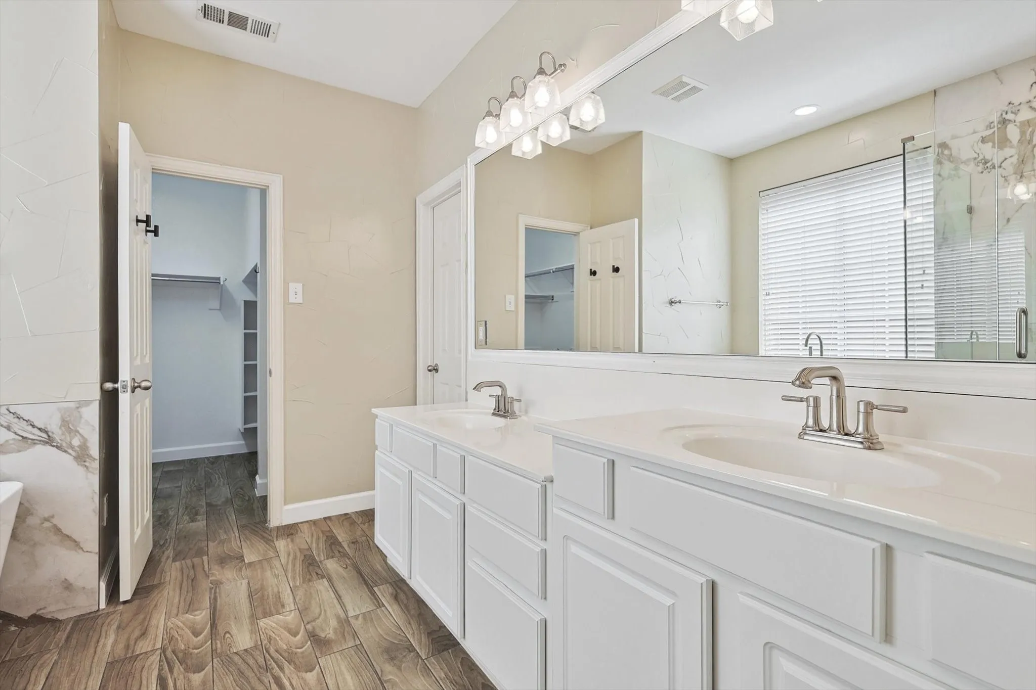 The primary bath features his and hers sinks.