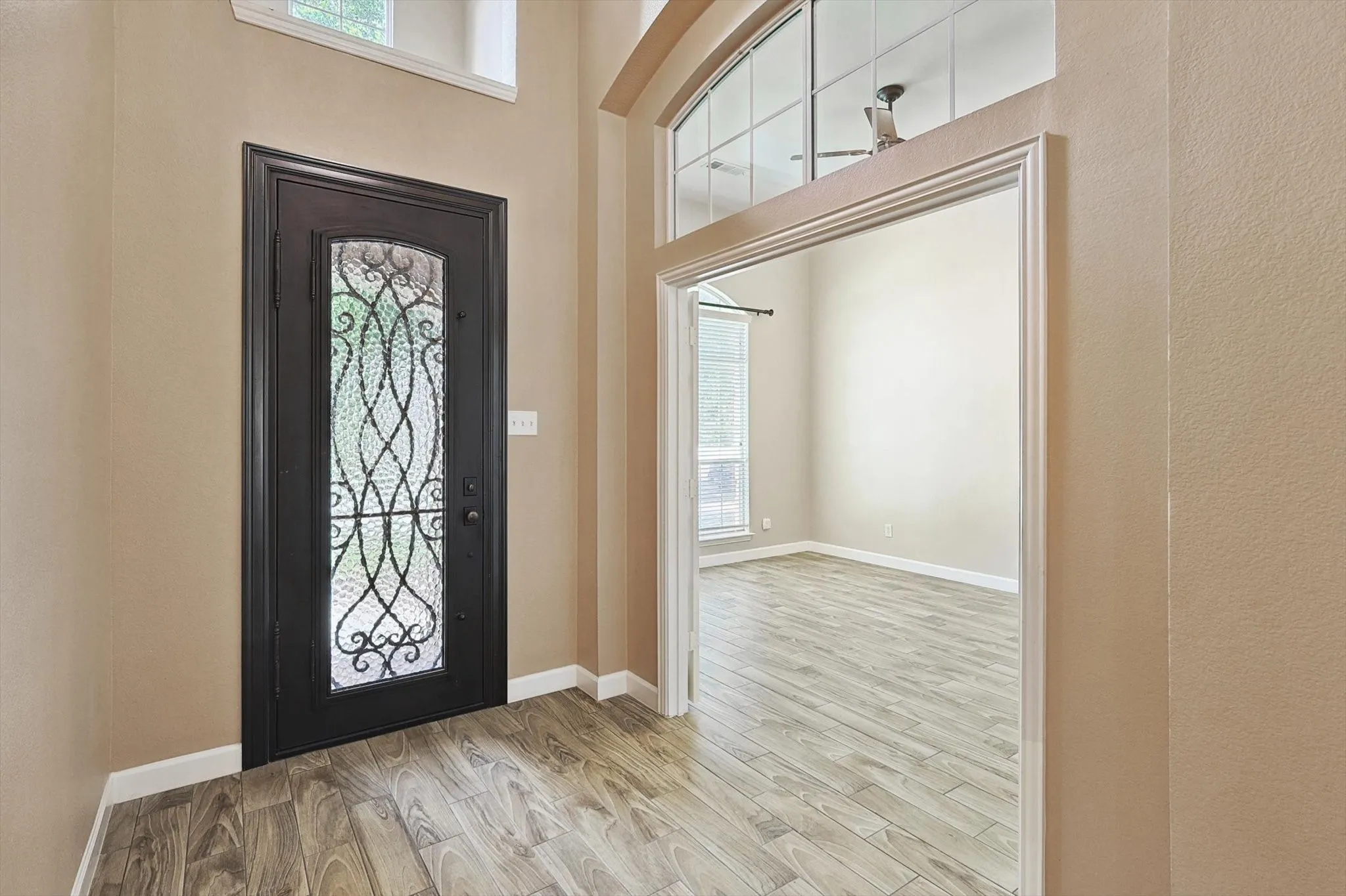 A spacious, light-filled entryway greets you as you enter this gorgeous home.
