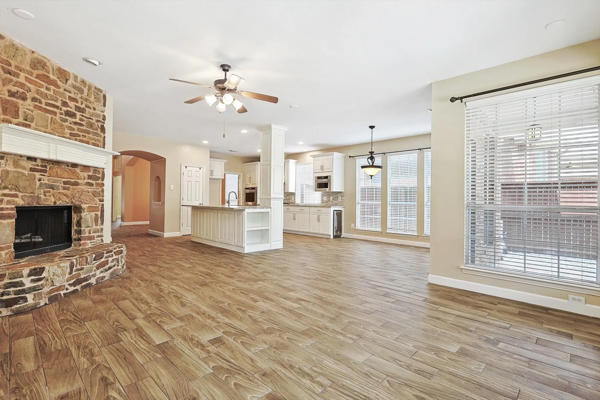 The impressive family room boasts an abundance of windows and is anchored by a custom fireplace.