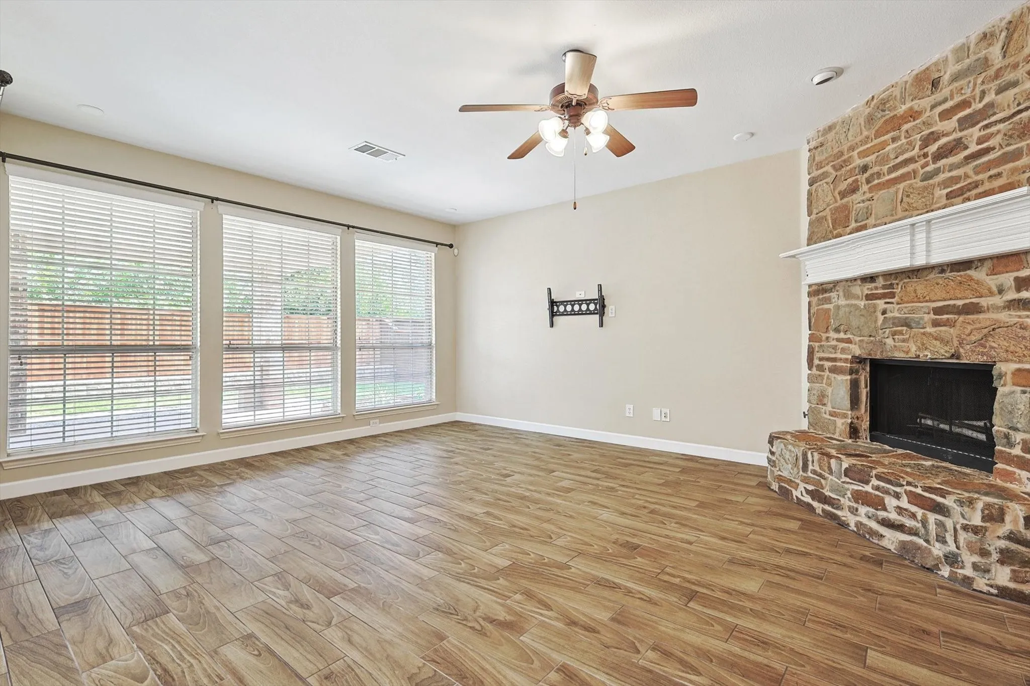 The family room boasts a wall of windows overlooking the backyard.