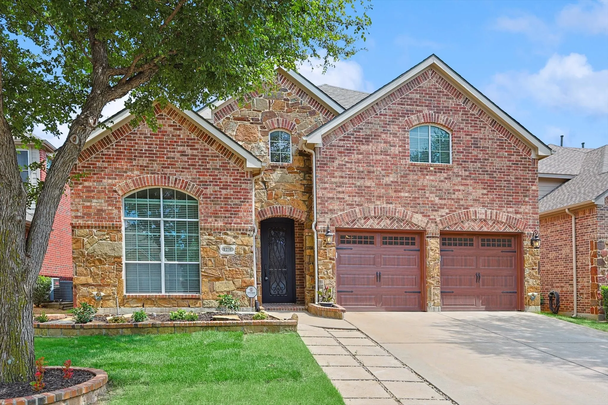 A gorgeous brick and rock elevation welcomes you to 1231 Golf Club Drive.