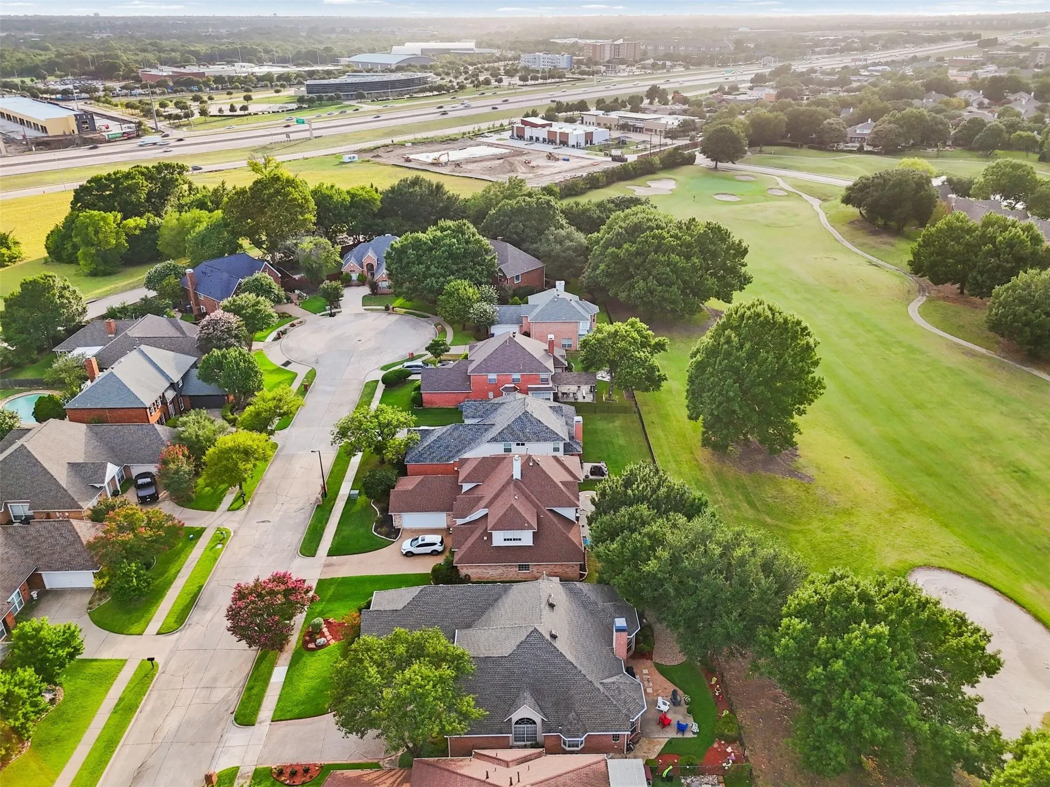Residential area featuring multiple homes with varied rooflines and brick exteriors