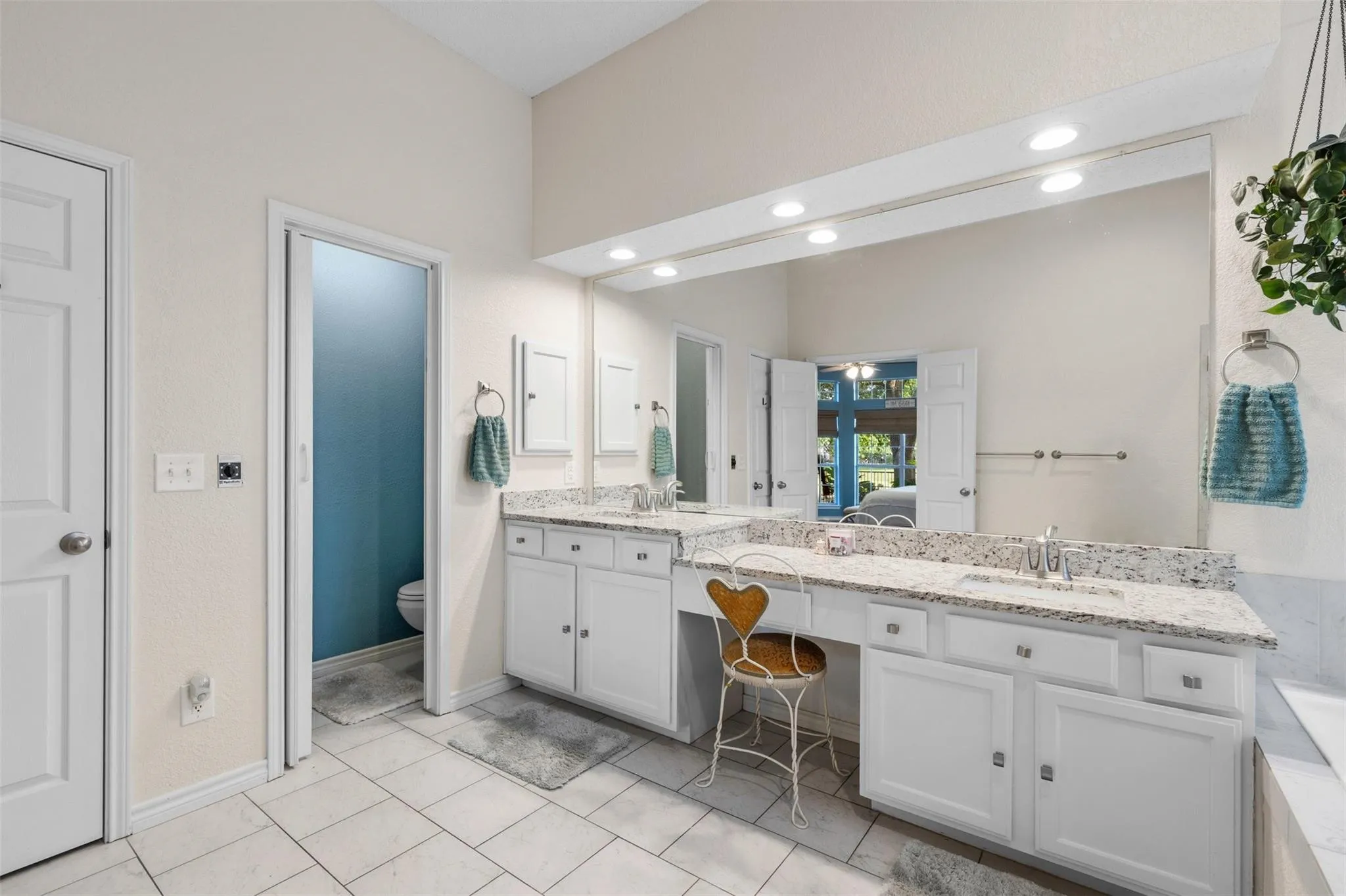 Dual vanity with light-colored countertops, white cabinetry, and undermount sinks