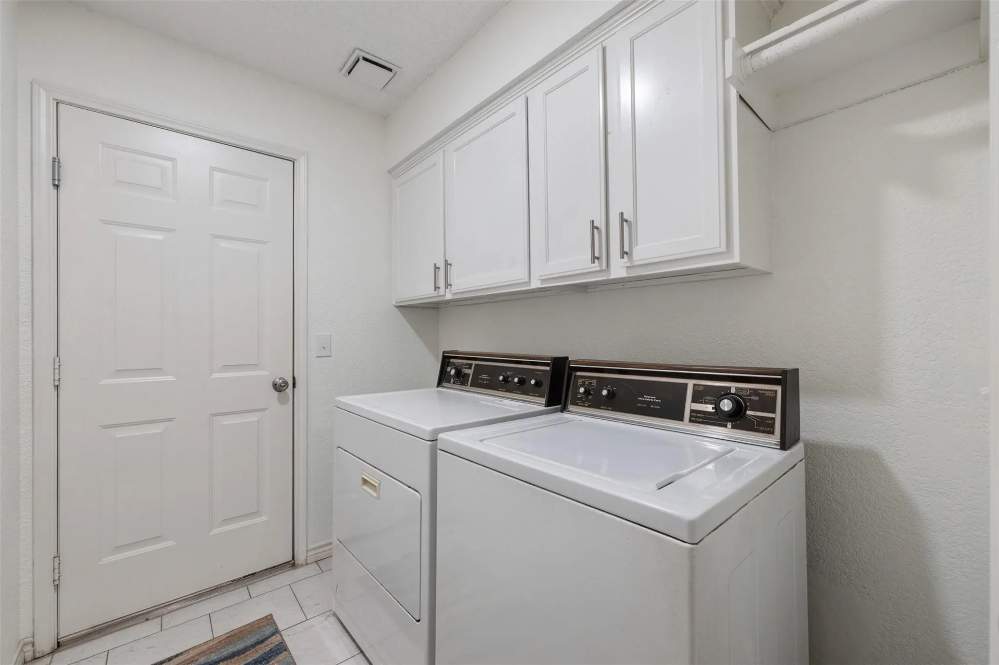 White shaker-style cabinetry with brushed nickel hardware