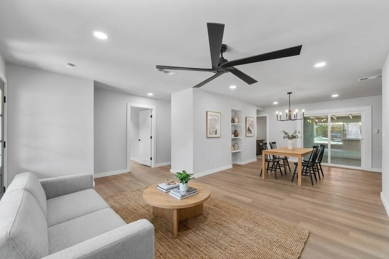 Recessed lighting, wood-finish flooring, built-in wall shelving, sliding glass door, and a modern ceiling fan