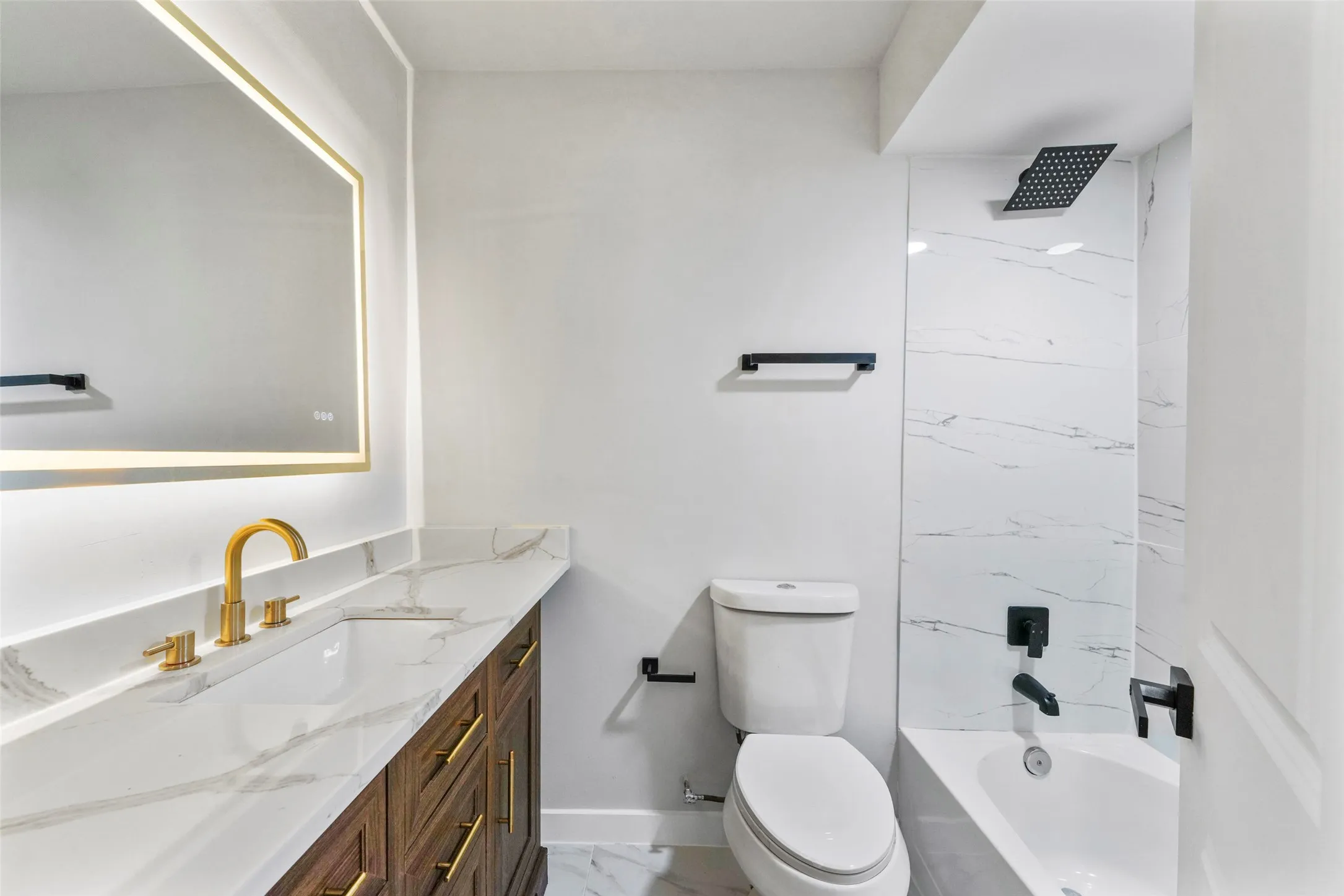Integrated vanity with a gold-finish faucet and under-mount sink
