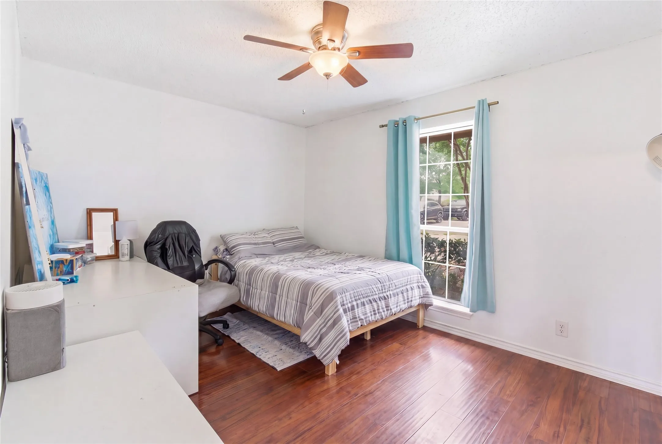 Wood-finish flooring with a ceiling fan light fixture