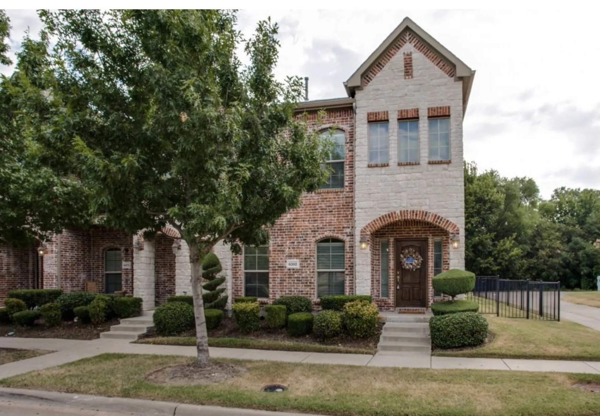 Brick and stone exterior with arched entryway