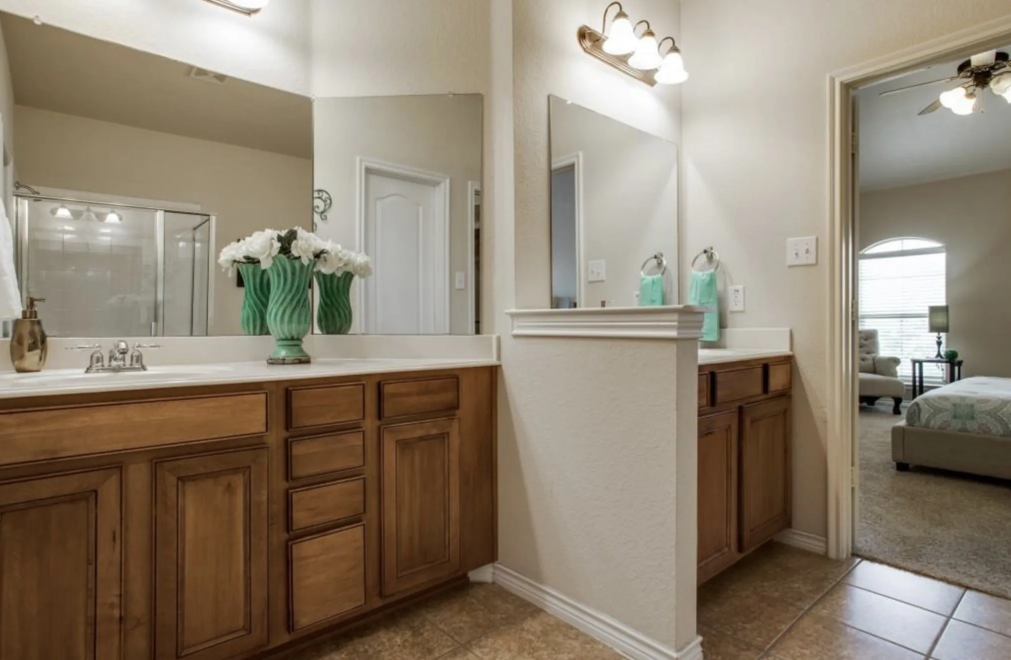 Dual vanity with wood-finish cabinetry and integrated sinks