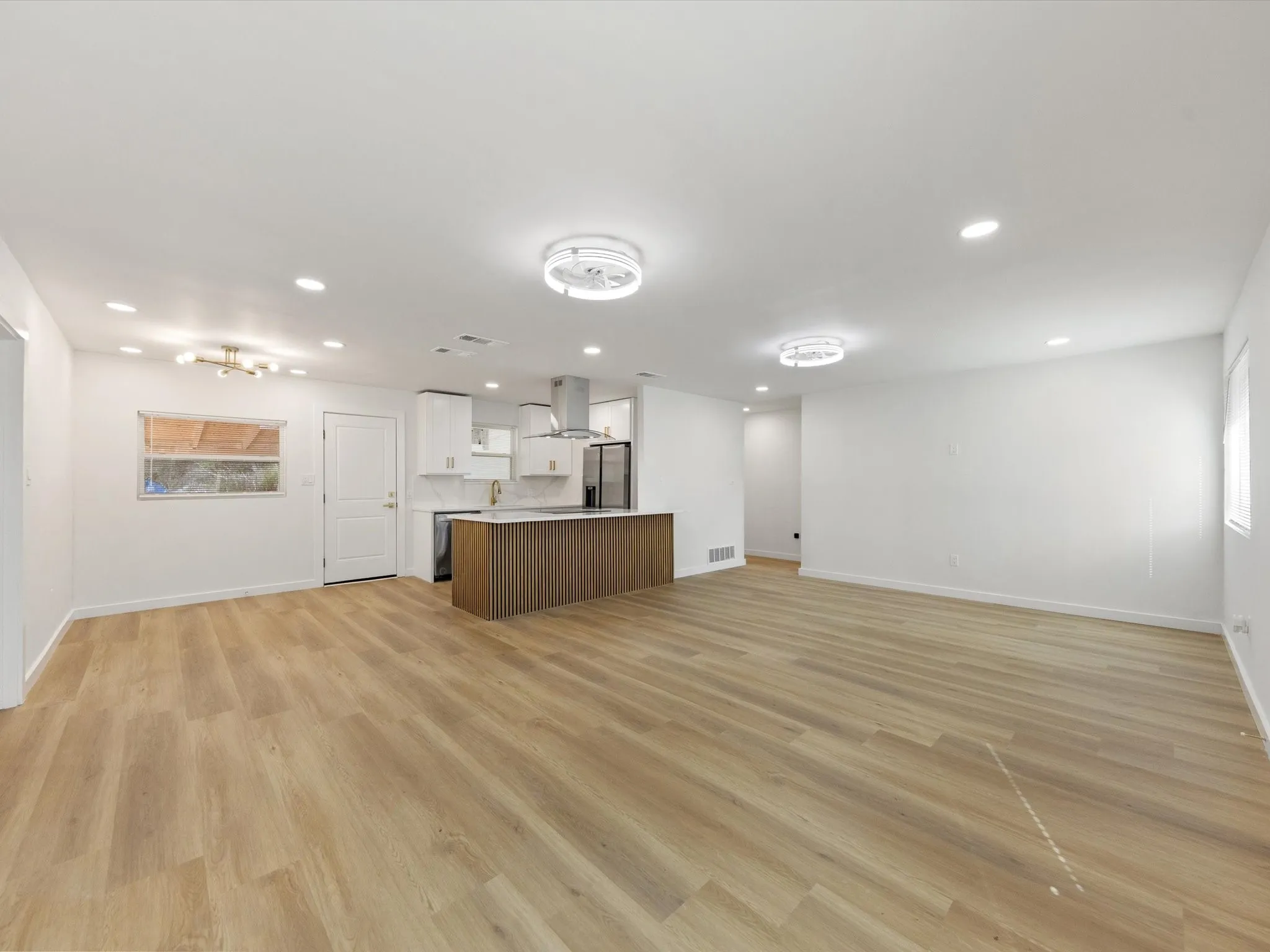 Open-concept layout with wood-finish flooring