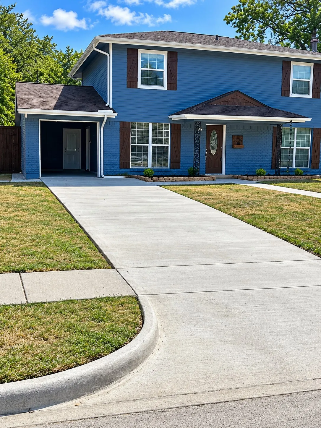 Two-story exterior with blue siding and brown shingle roof