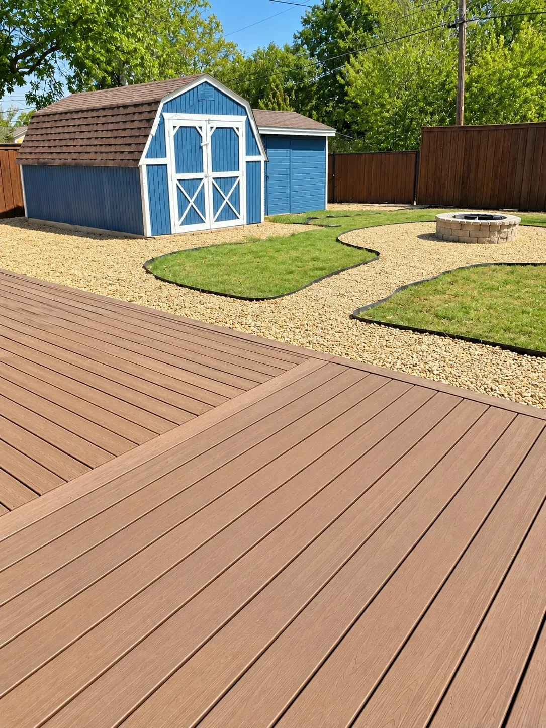 Expansive outdoor living area featuring a multi-level deck, gravel pathways, and a built-in fire pit