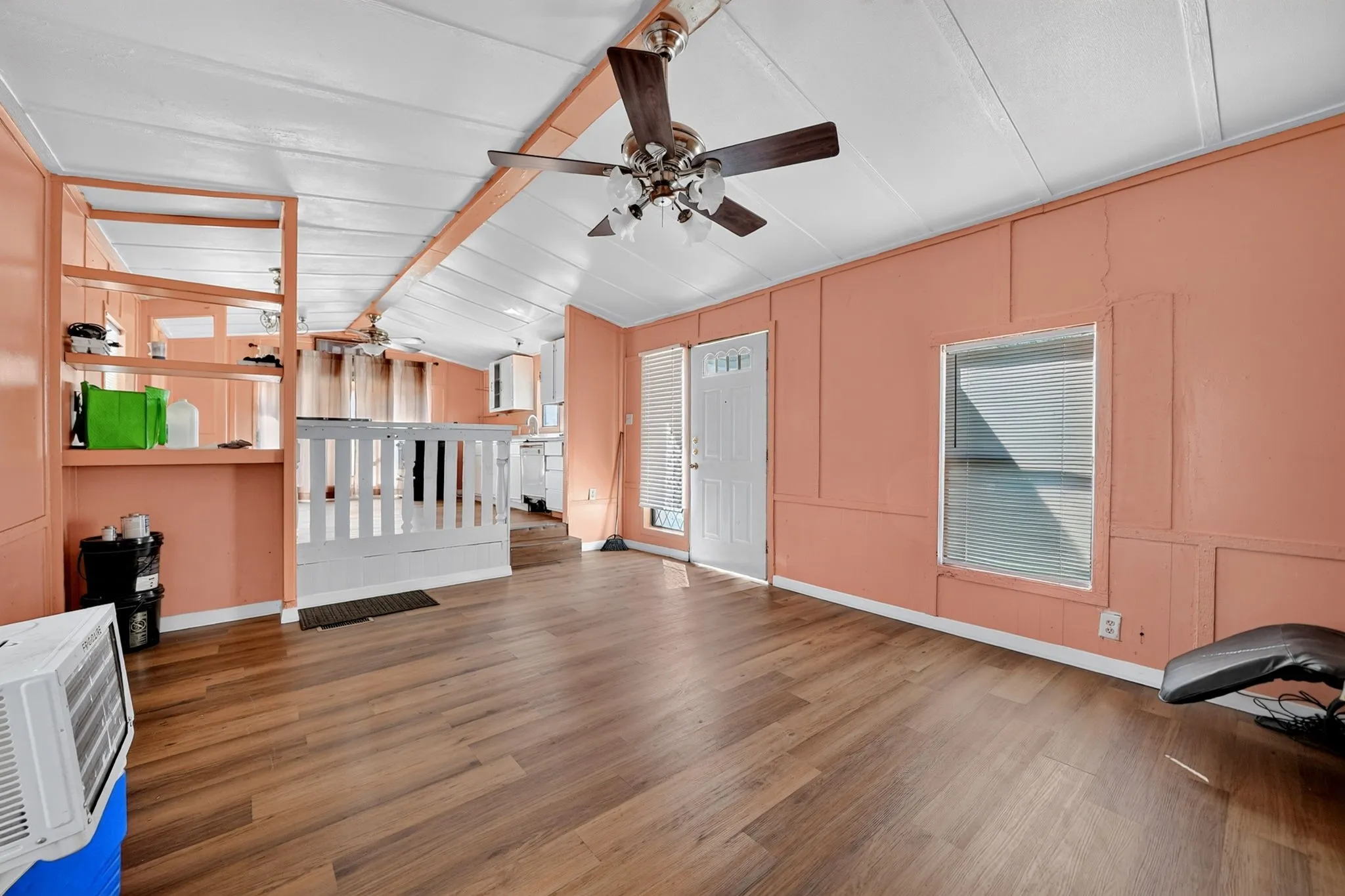 Wood-finish flooring throughout, with a ceiling fan overhead