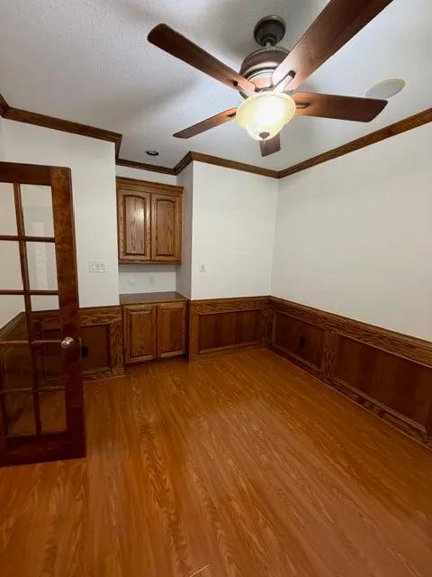 Wood-finish flooring with wainscoting and crown molding
