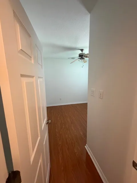 Wood-finish flooring with white baseboards