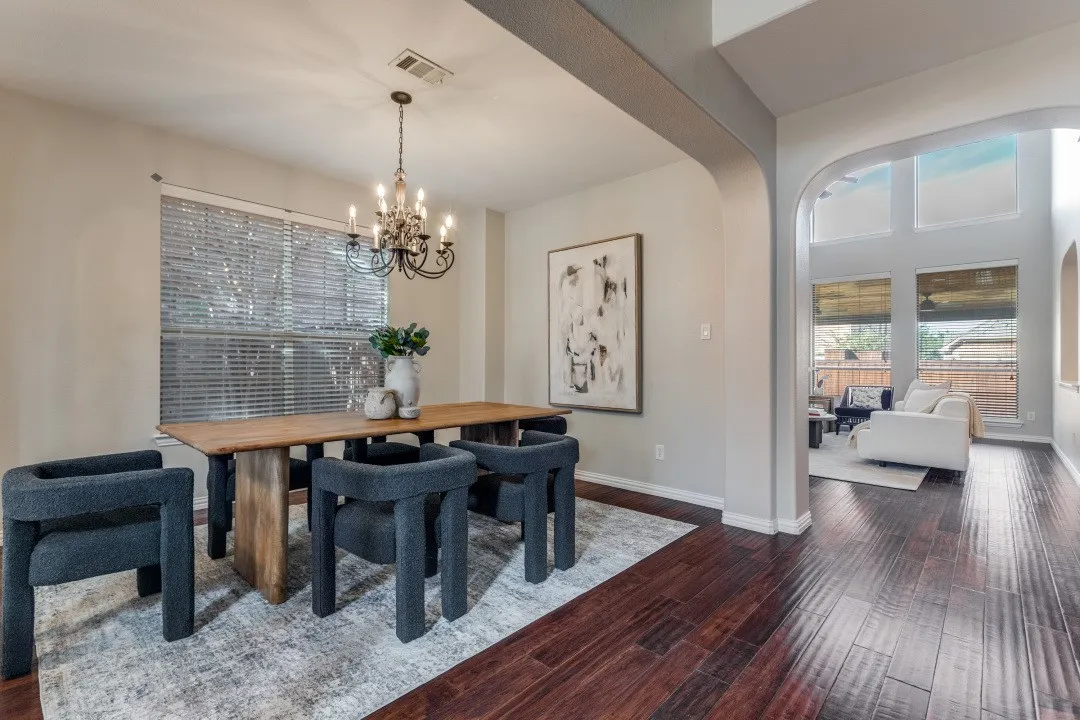 Dark wood-finish flooring extending through arched doorways
