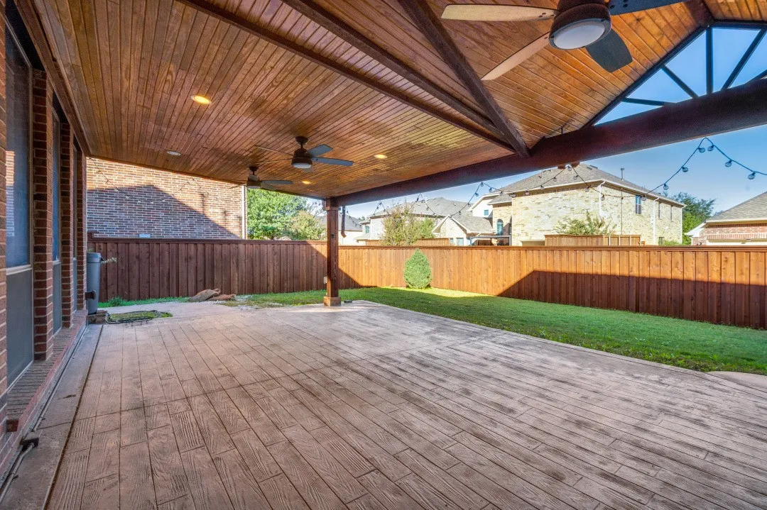 Expansive covered patio with a stained wood-finish ceiling, recessed lighting, and ceiling fans