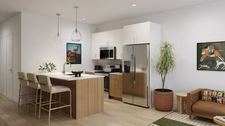 Kitchen featuring appliances with stainless steel finishes, a kitchen breakfast bar, hanging light fixtures, white cabinetry, and decorative backsplash