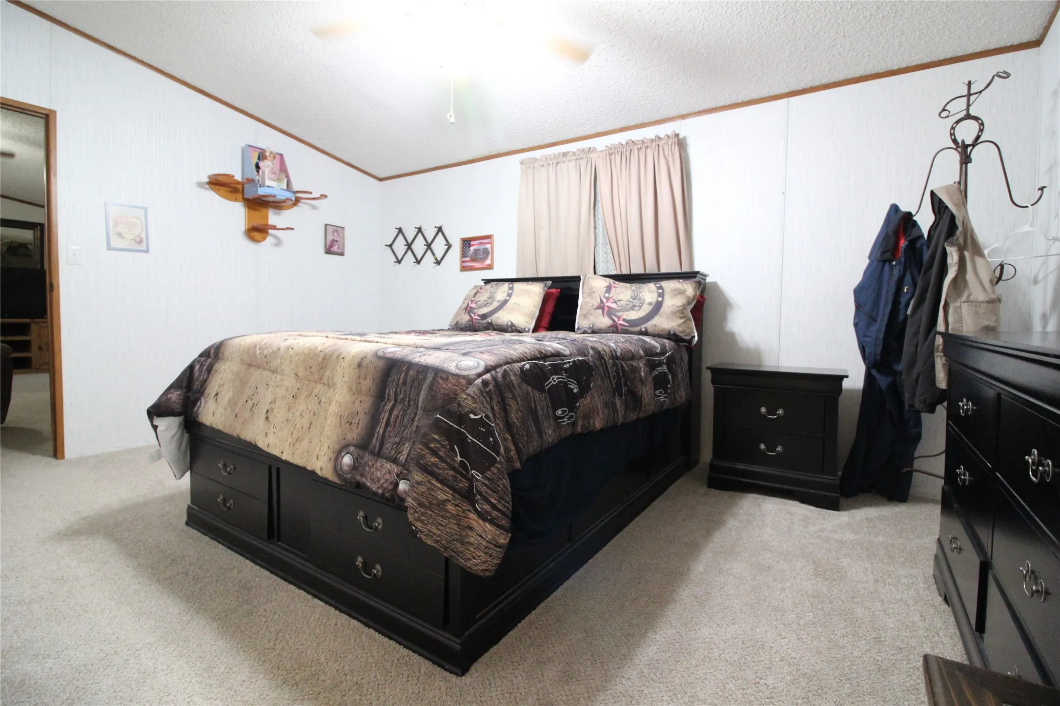 Wall-to-wall carpeting and paneled walls with wood trim