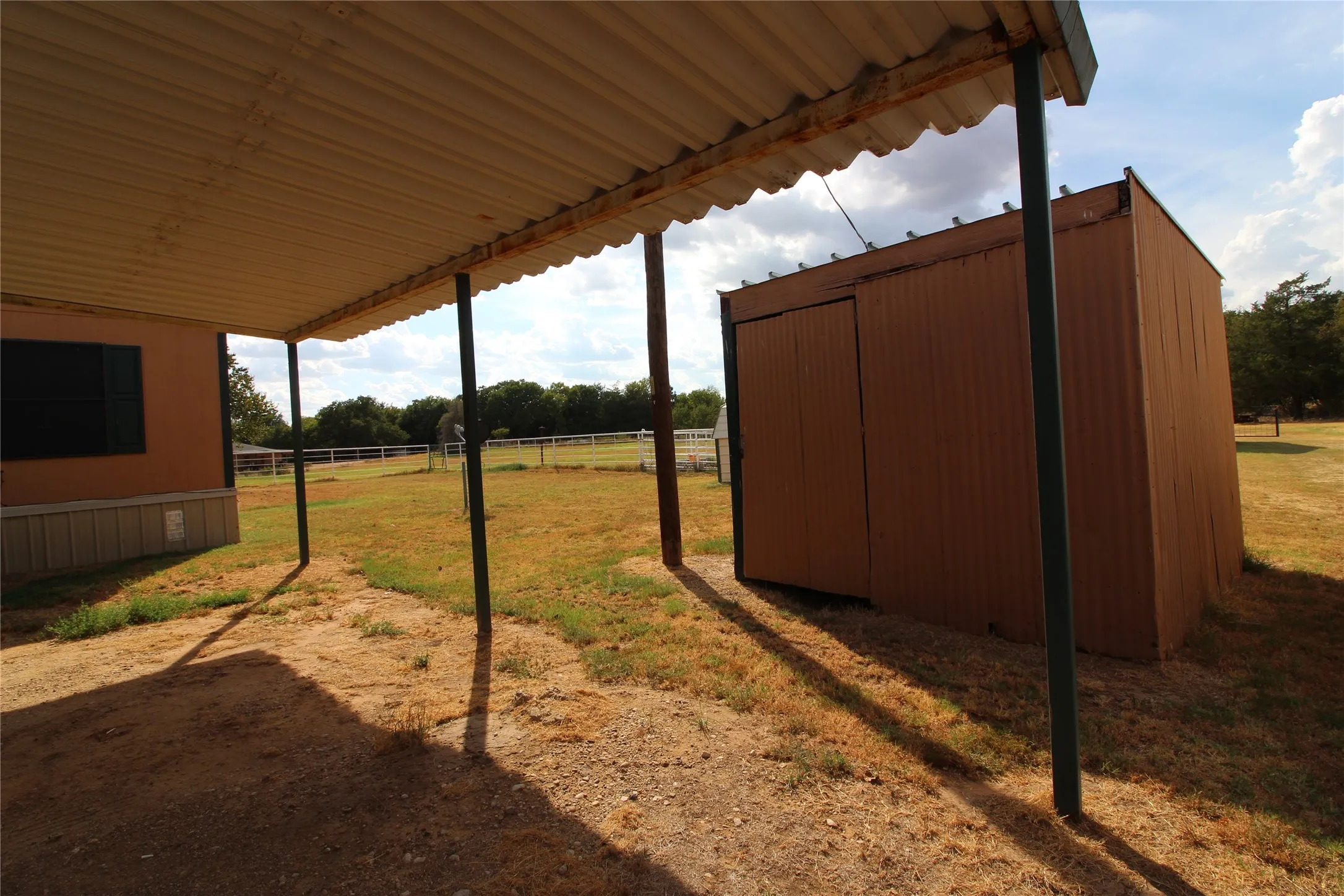Covered patio space with metal roofing and support columns