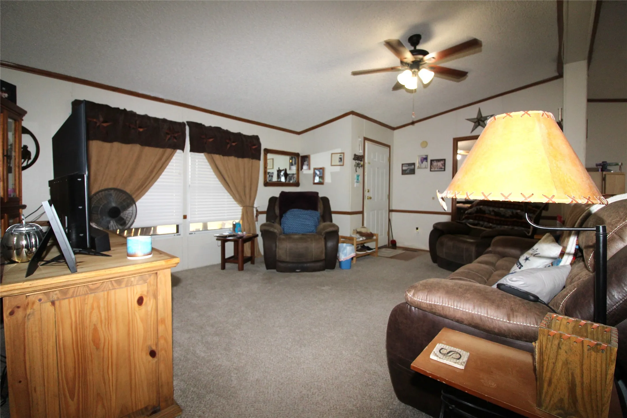 Recessed windows with blinds, wood-finish trim, and a ceiling fan with integrated lighting