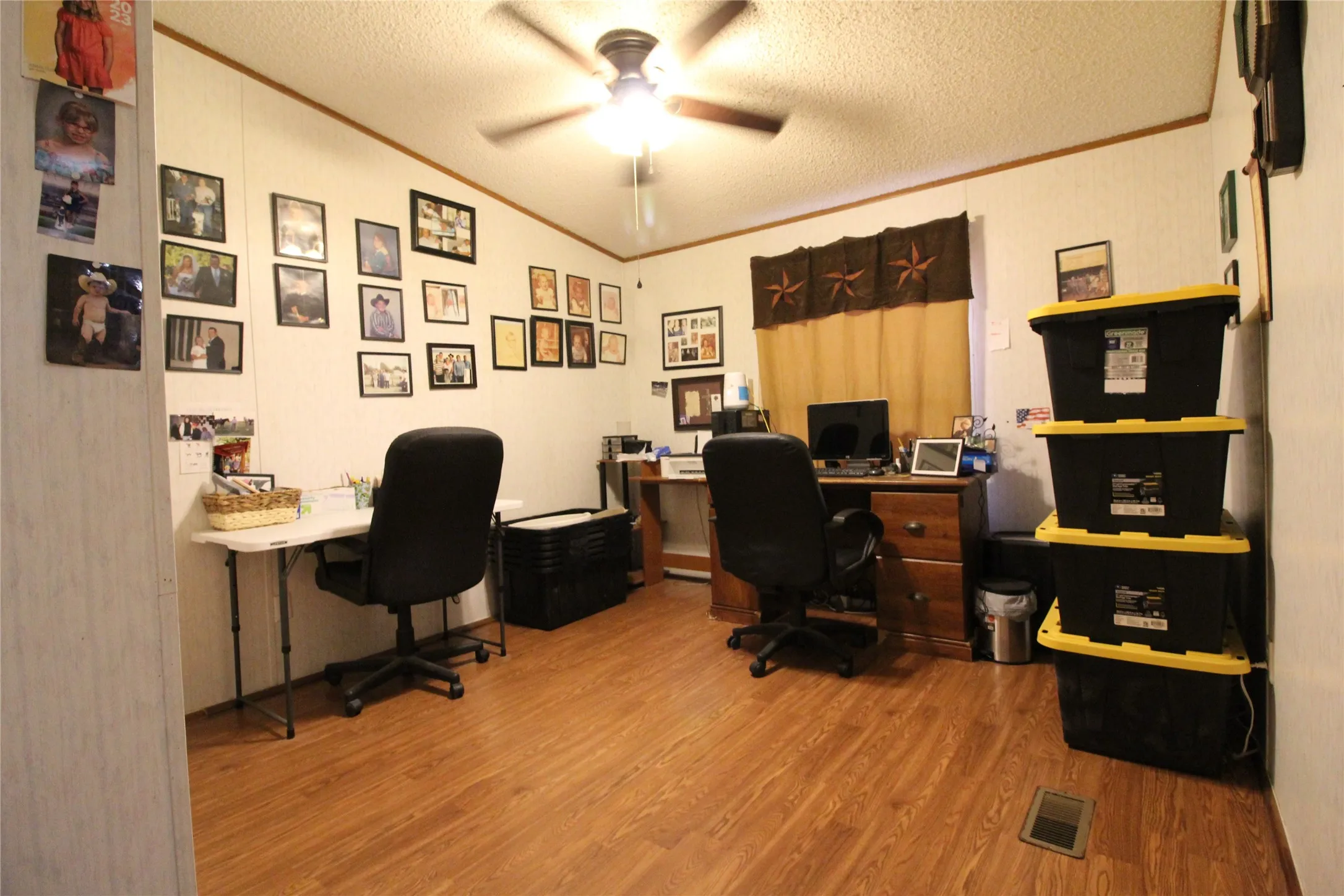 Wood-finish flooring with a ceiling fan light fixture