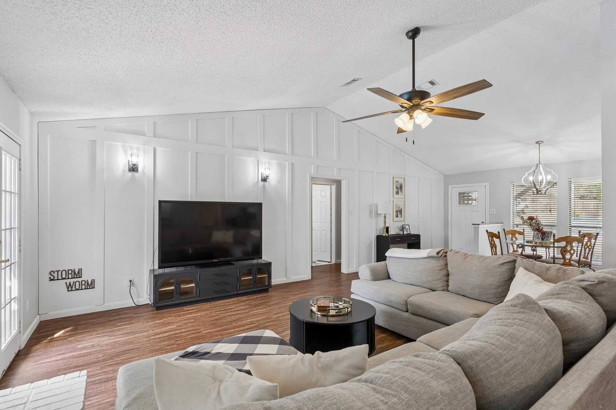 Living room with view of new accent wall and wall sconces