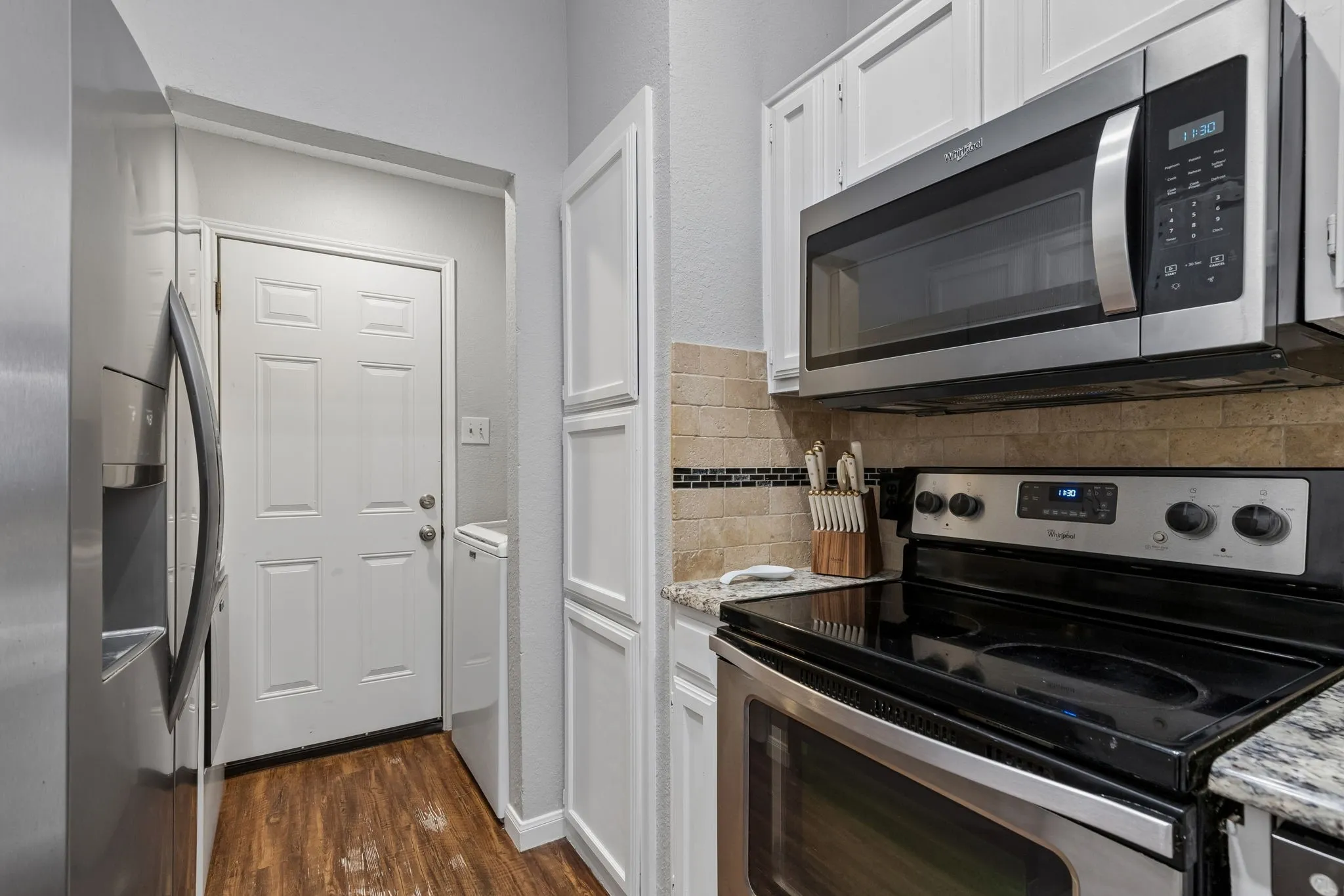 Kitchen leading to laundry area and garage