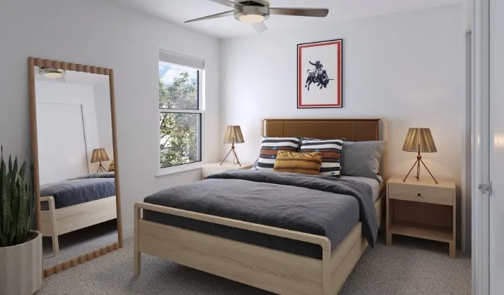 Carpeted bedroom featuring ceiling fan