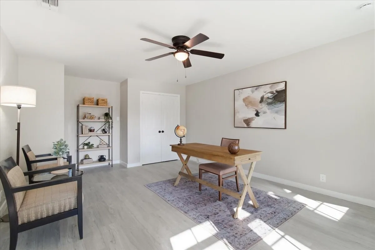 Light wood-finish flooring, recessed lighting, and a ceiling fan with integrated lighting
