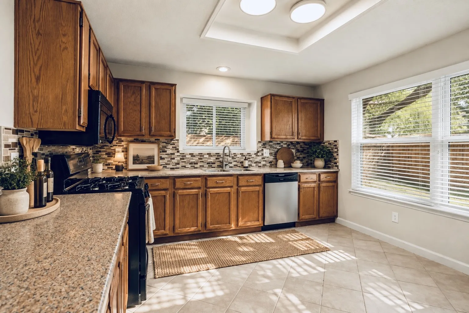 Kitchen featuring wood cabinetry, solid surface countertops, a mosaic tile backsplash, stainless steel appliances, and tiled flooring