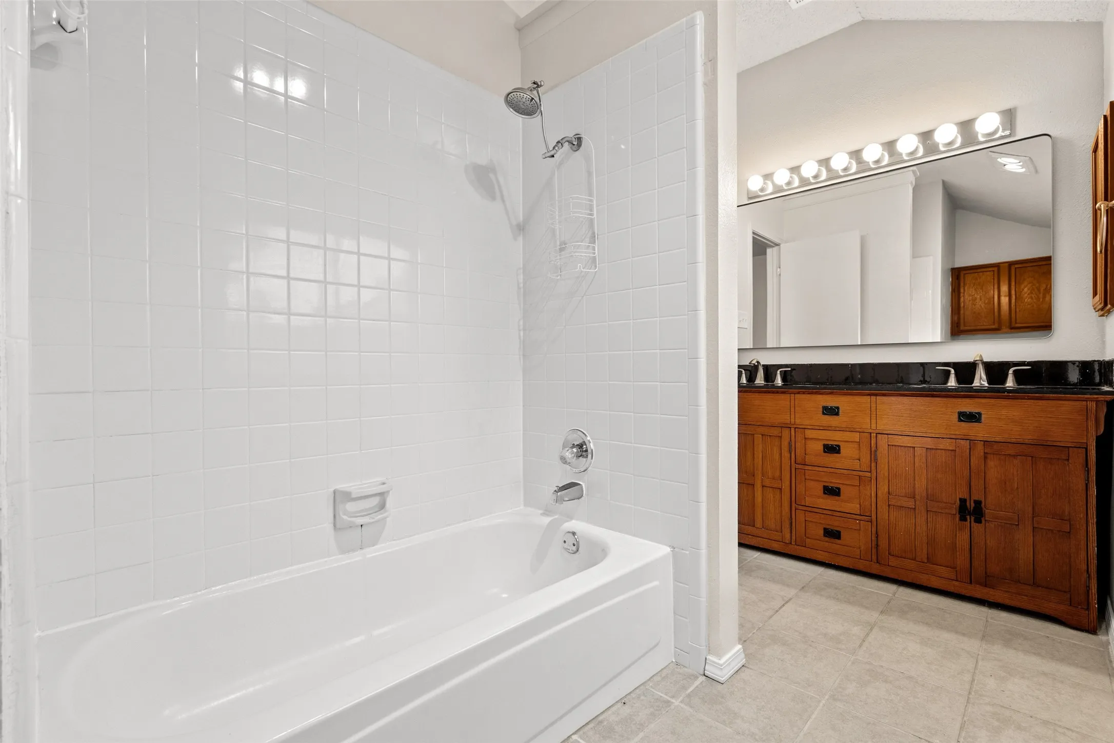 White tiled shower surround with a tub