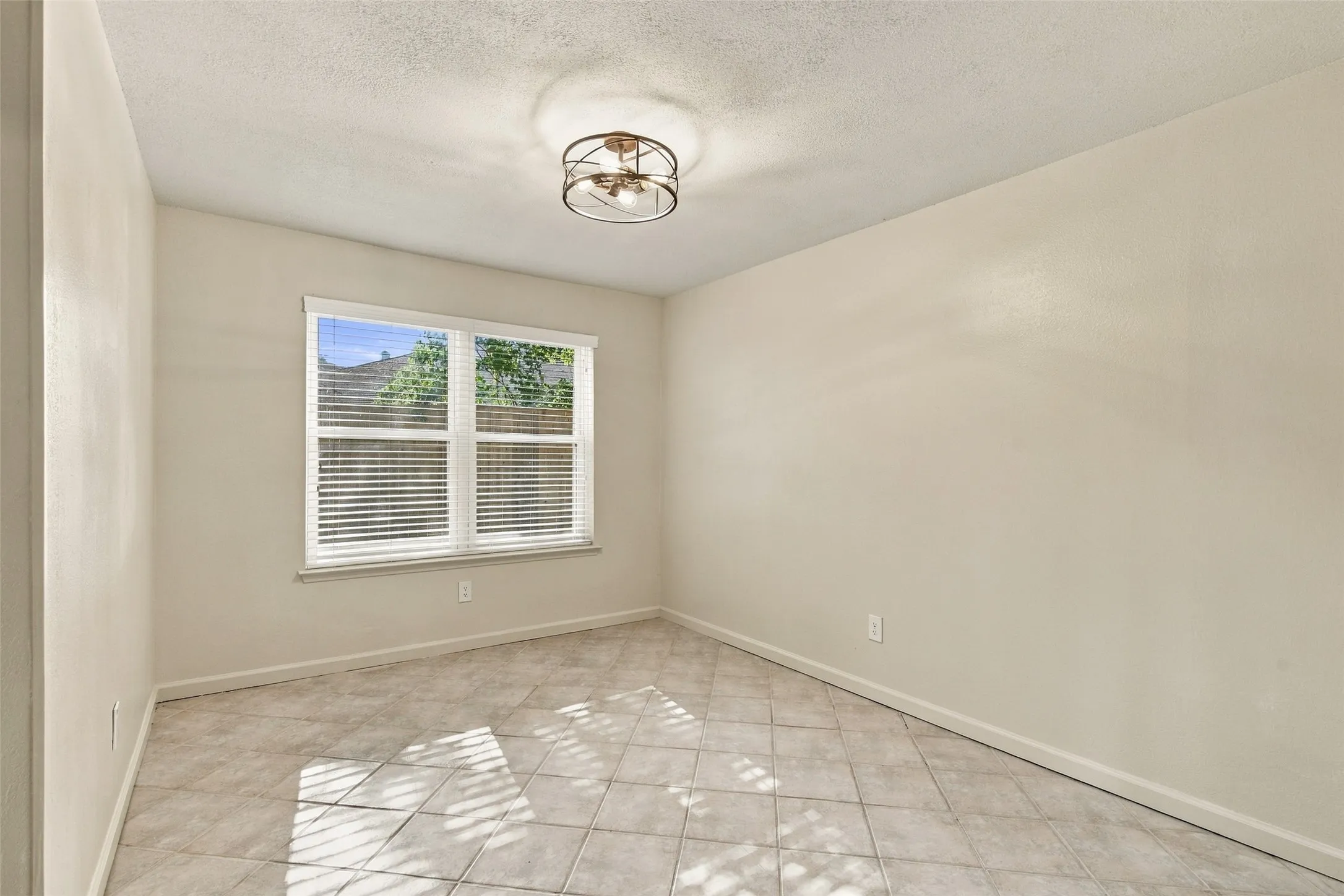 Recessed window with white blinds, neutral wall tones, and tiled flooring