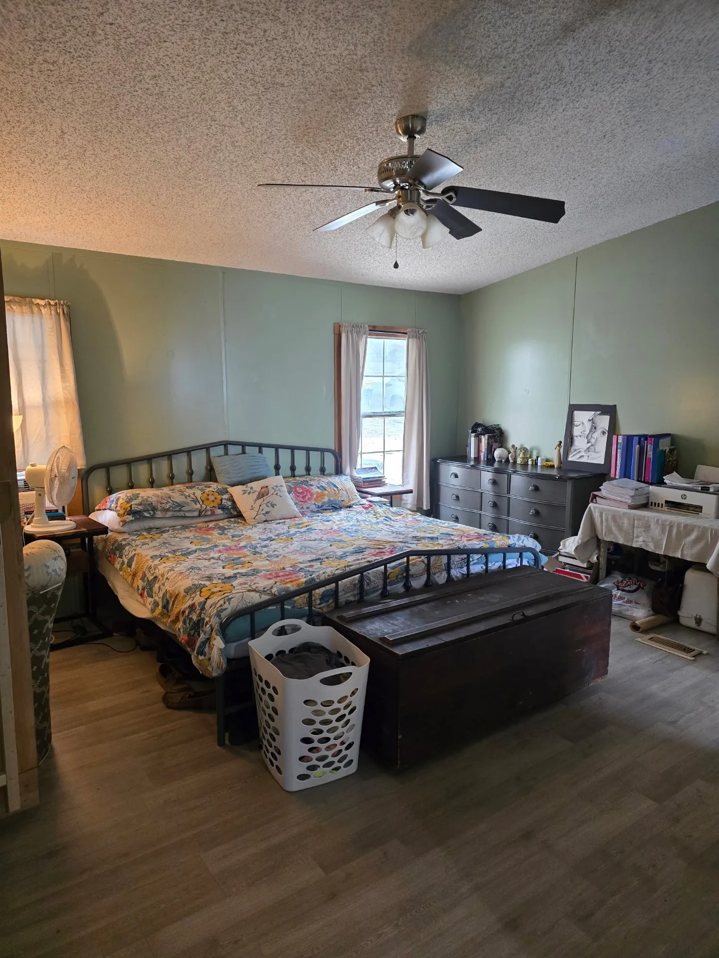 Wood-finish flooring with a ceiling fan light fixture