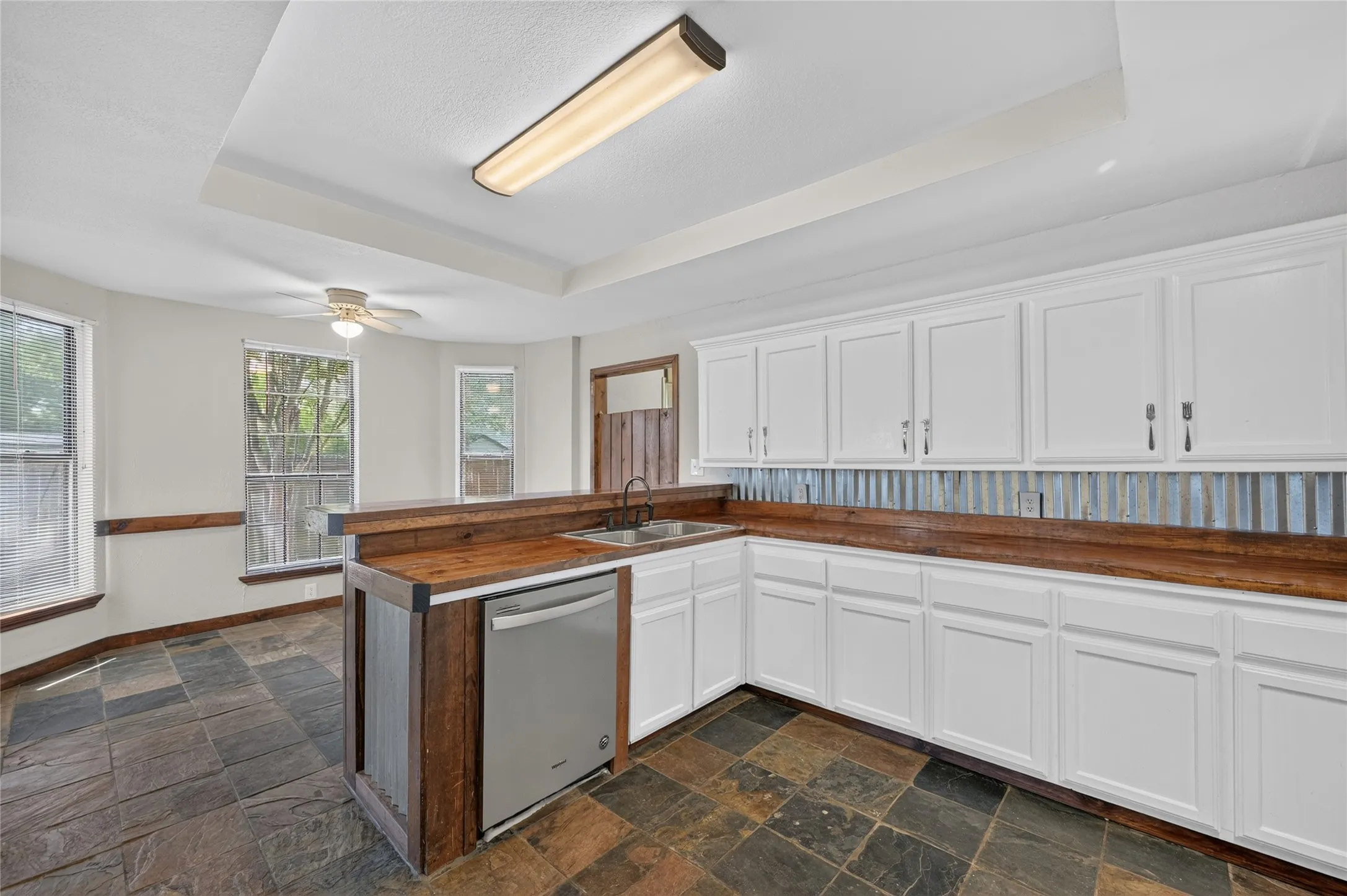 White cabinetry with wood-finish countertops