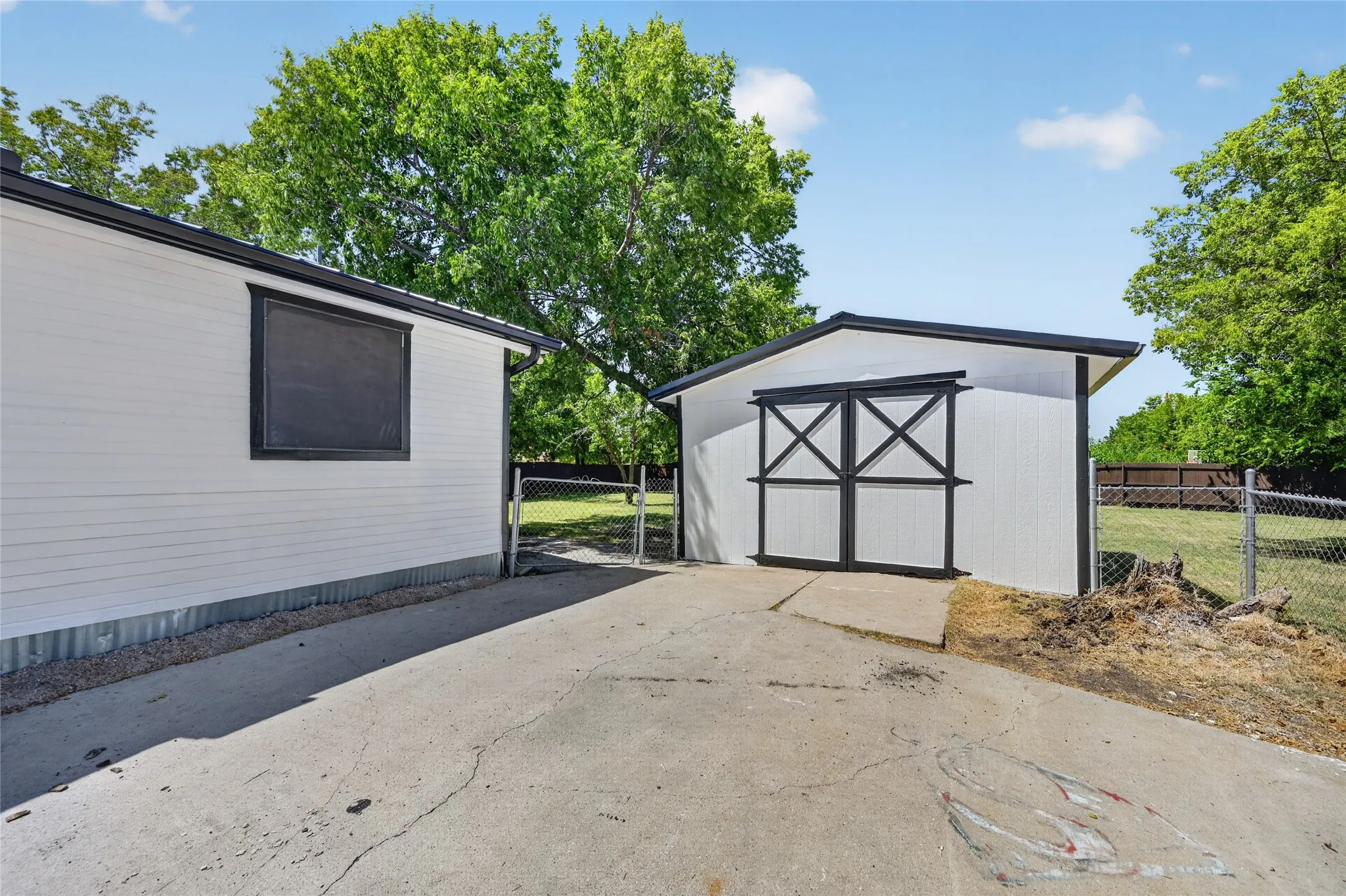 Exterior with white horizontal siding and black trim accents