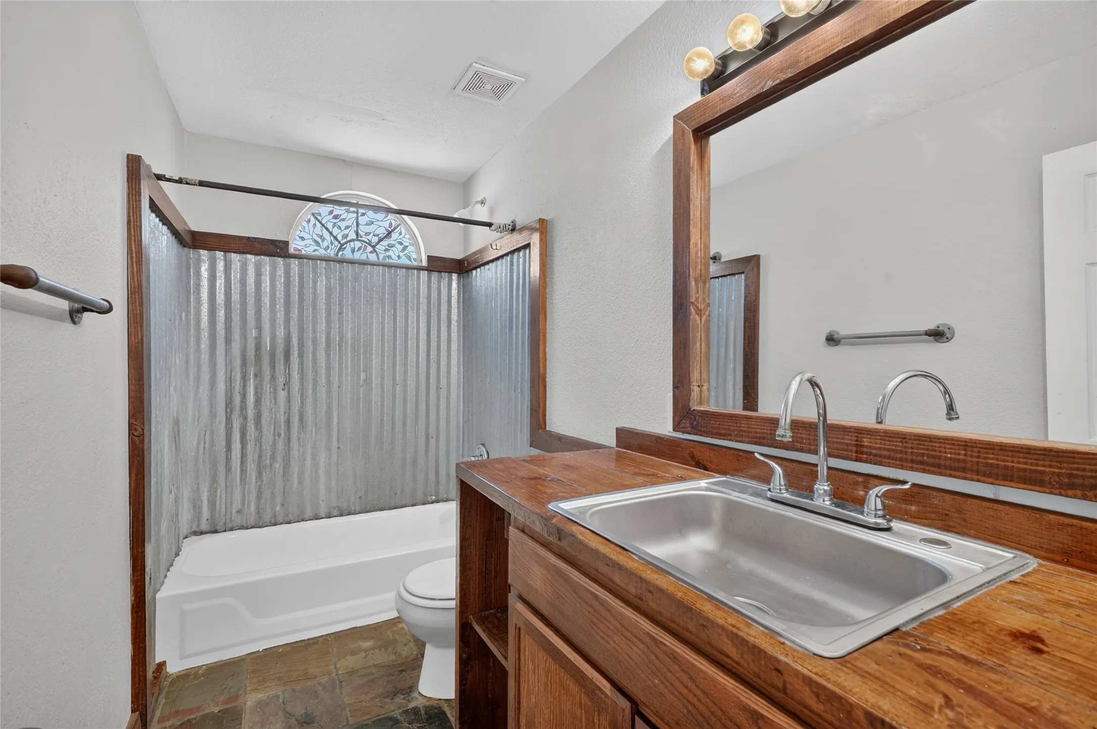 Wood-finish vanity with an integrated stainless steel sink