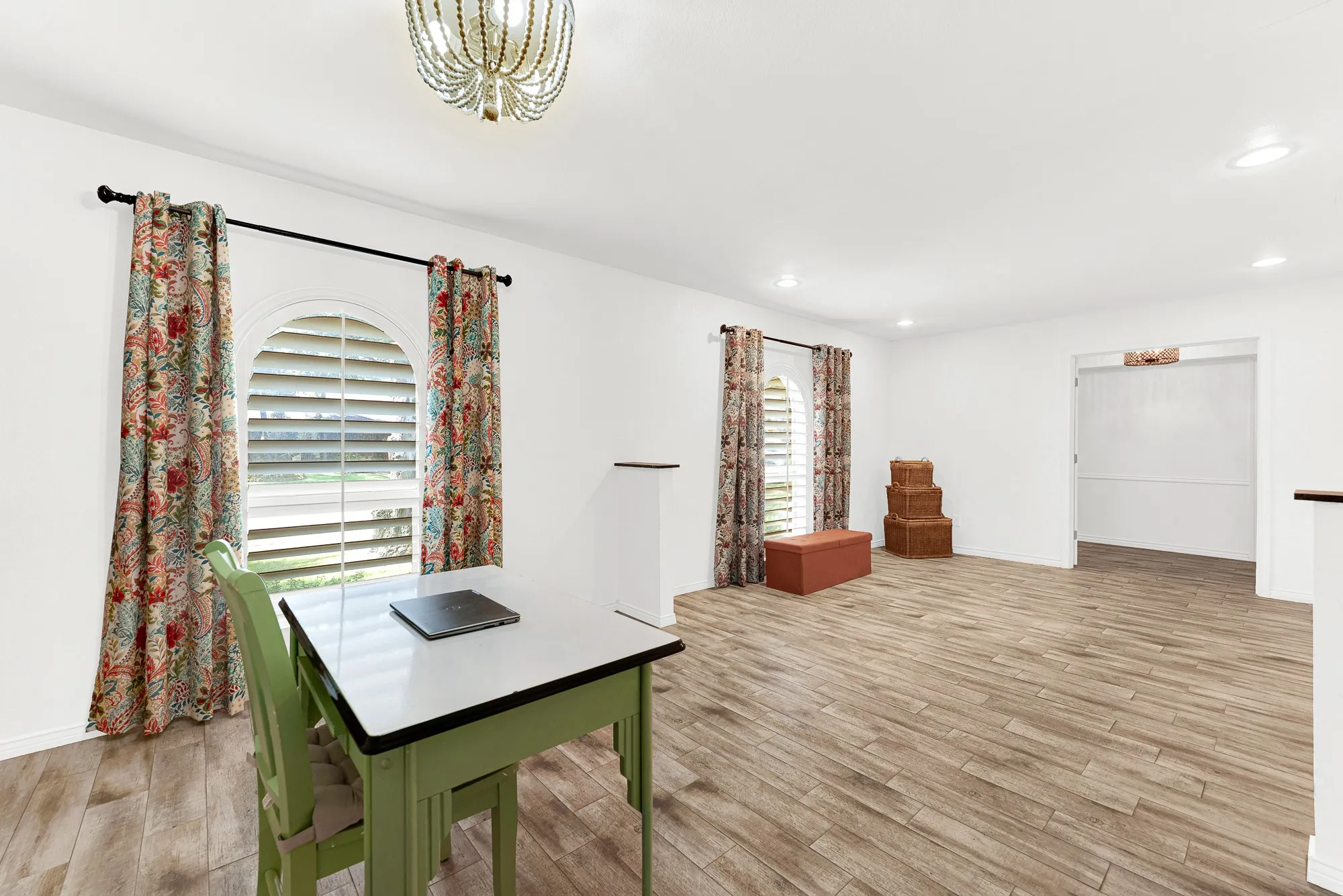 Arched cottage-style windows bring rich architectural character to this open-concept room. Whether transformed into a quiet library, music room, or dedicated home gym, the spacious floor plan easily adapts as your lifestyle evolves.
